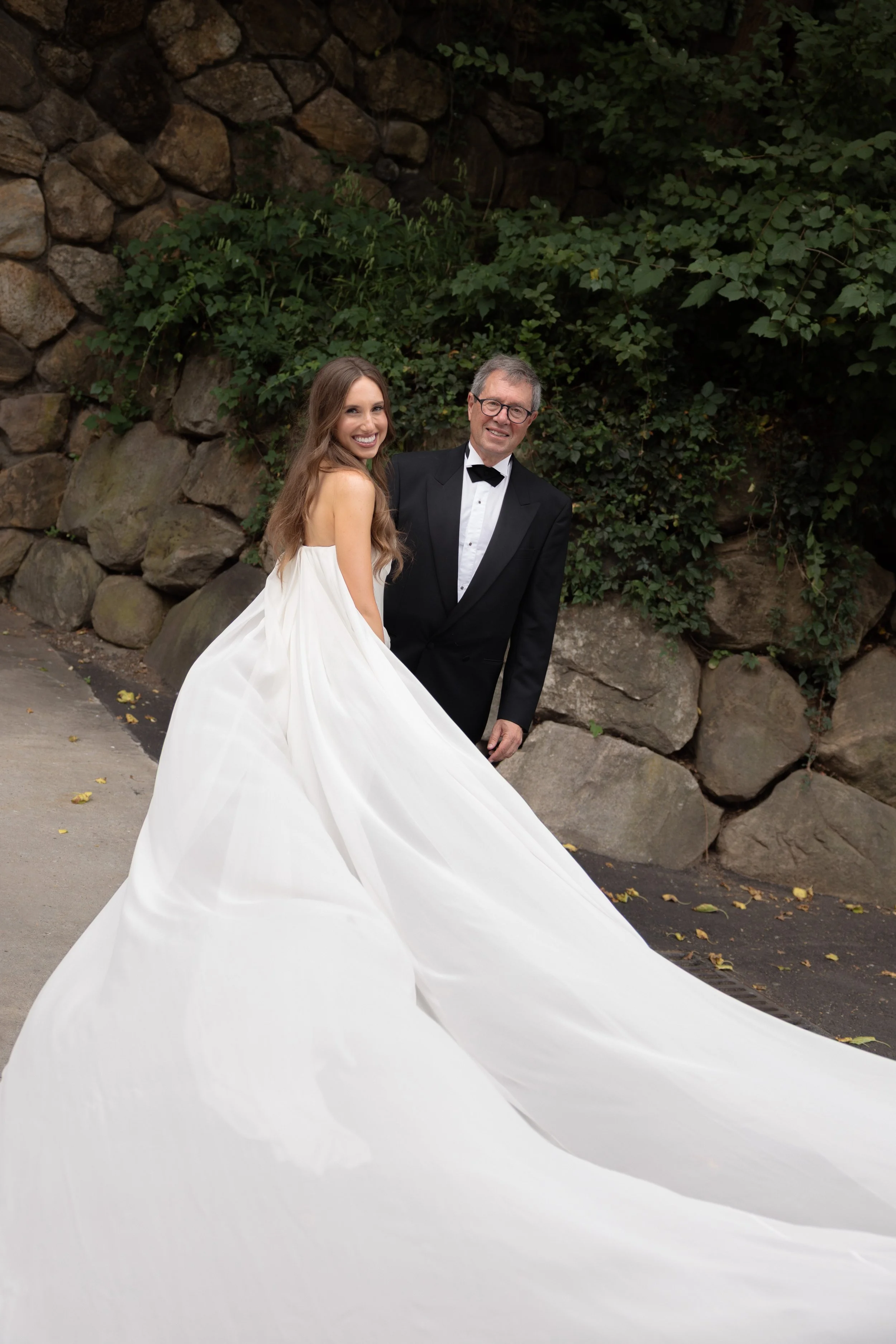 Jennie, wearing the dramatic Galaxy cape, embraces her father on her wedding day.