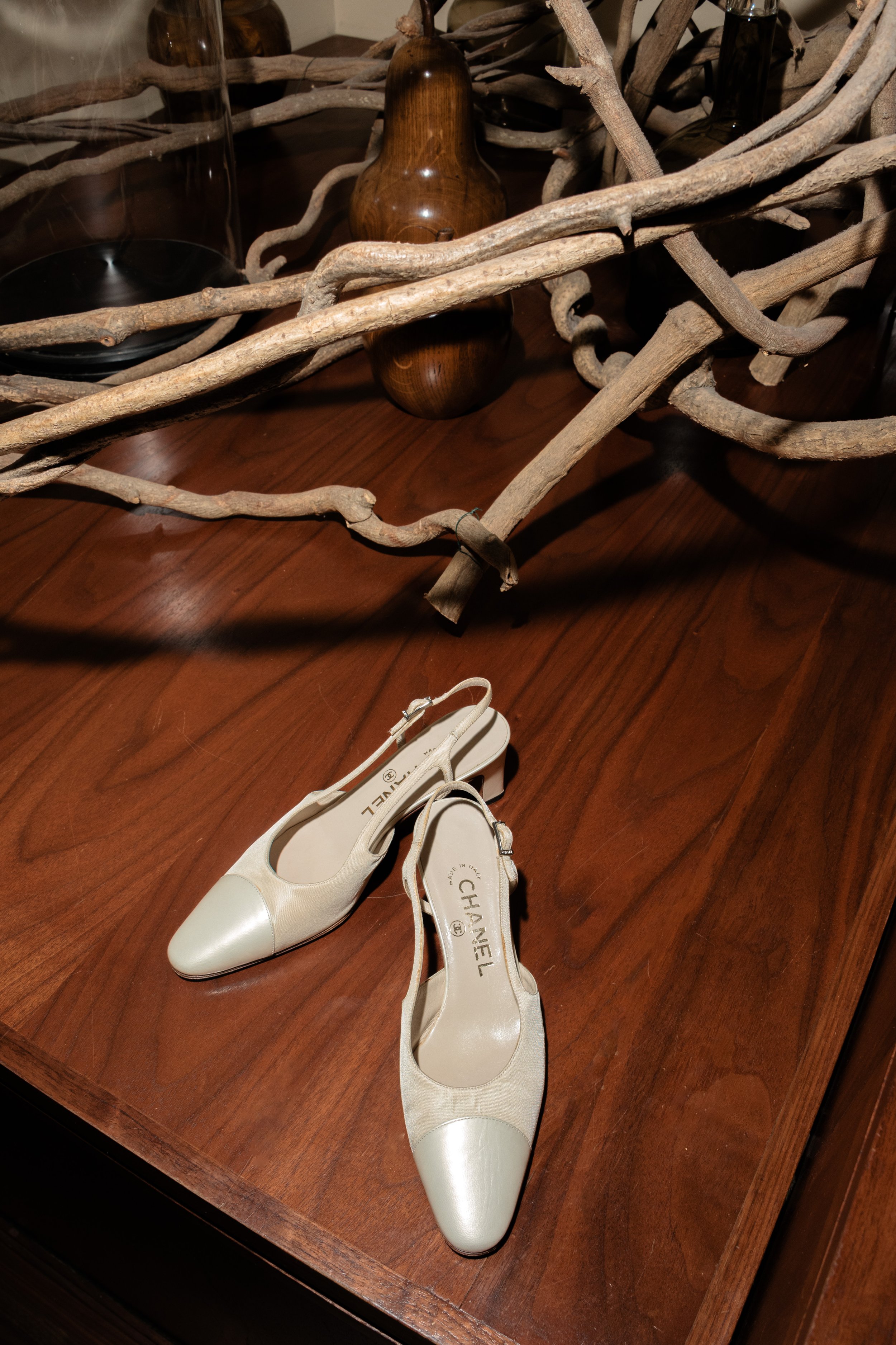 Vintage cream Chanel slingback pumps complement the neutral wood and organic textures of the rustic Hudson Valley wedding venue perfectly. 