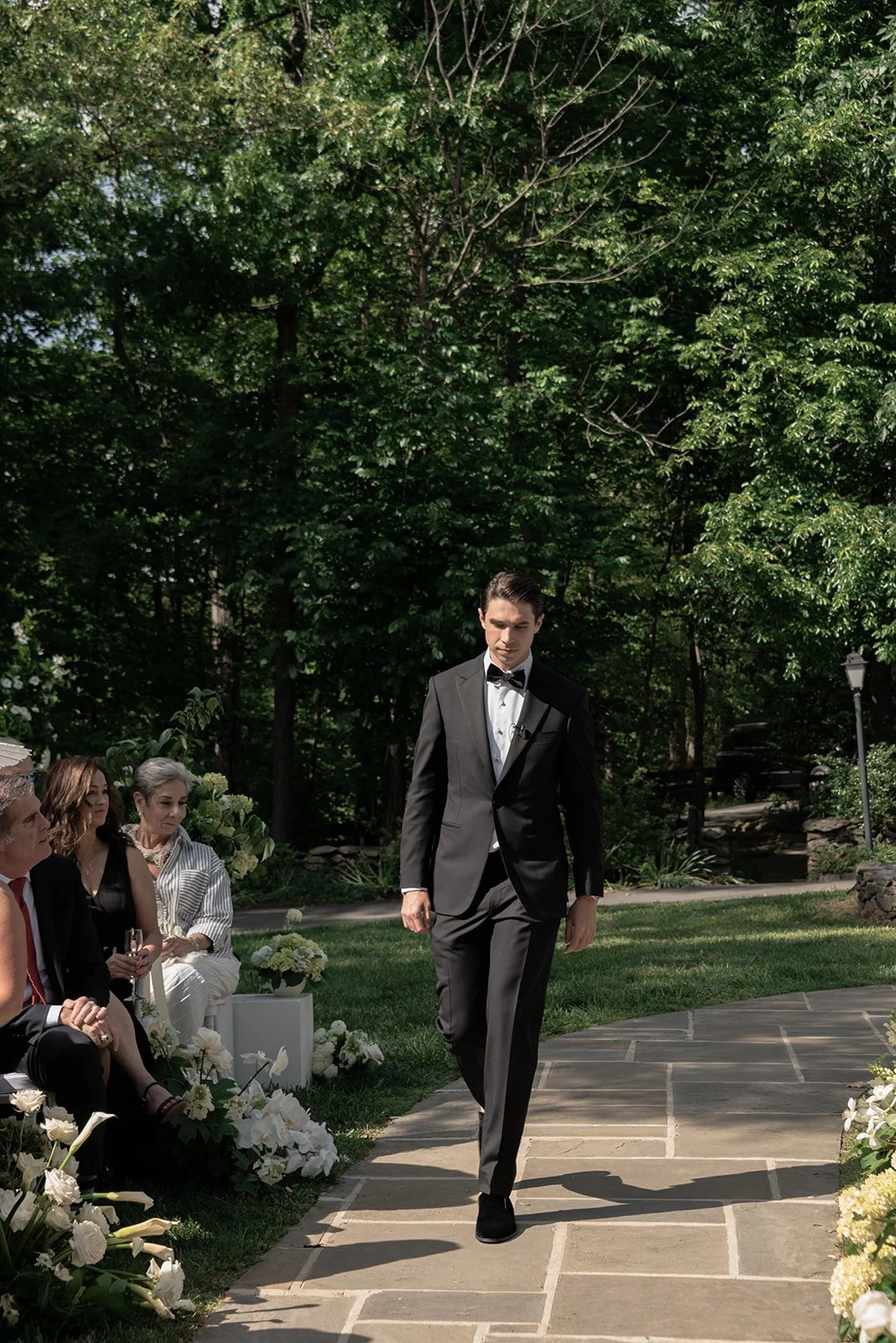 Groom makes his way down the aisle at the Ivy Wall
