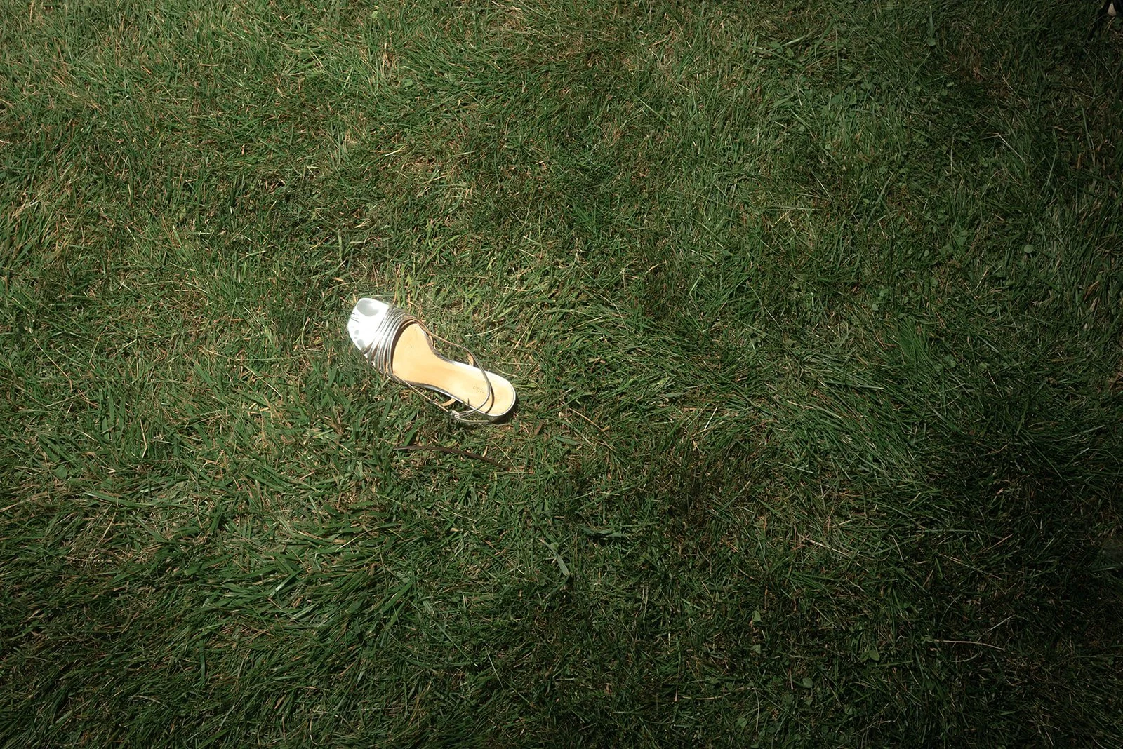 A single shoe left behind in the grass by a wedding guest during this late-night reception at Goodstone Inn. 