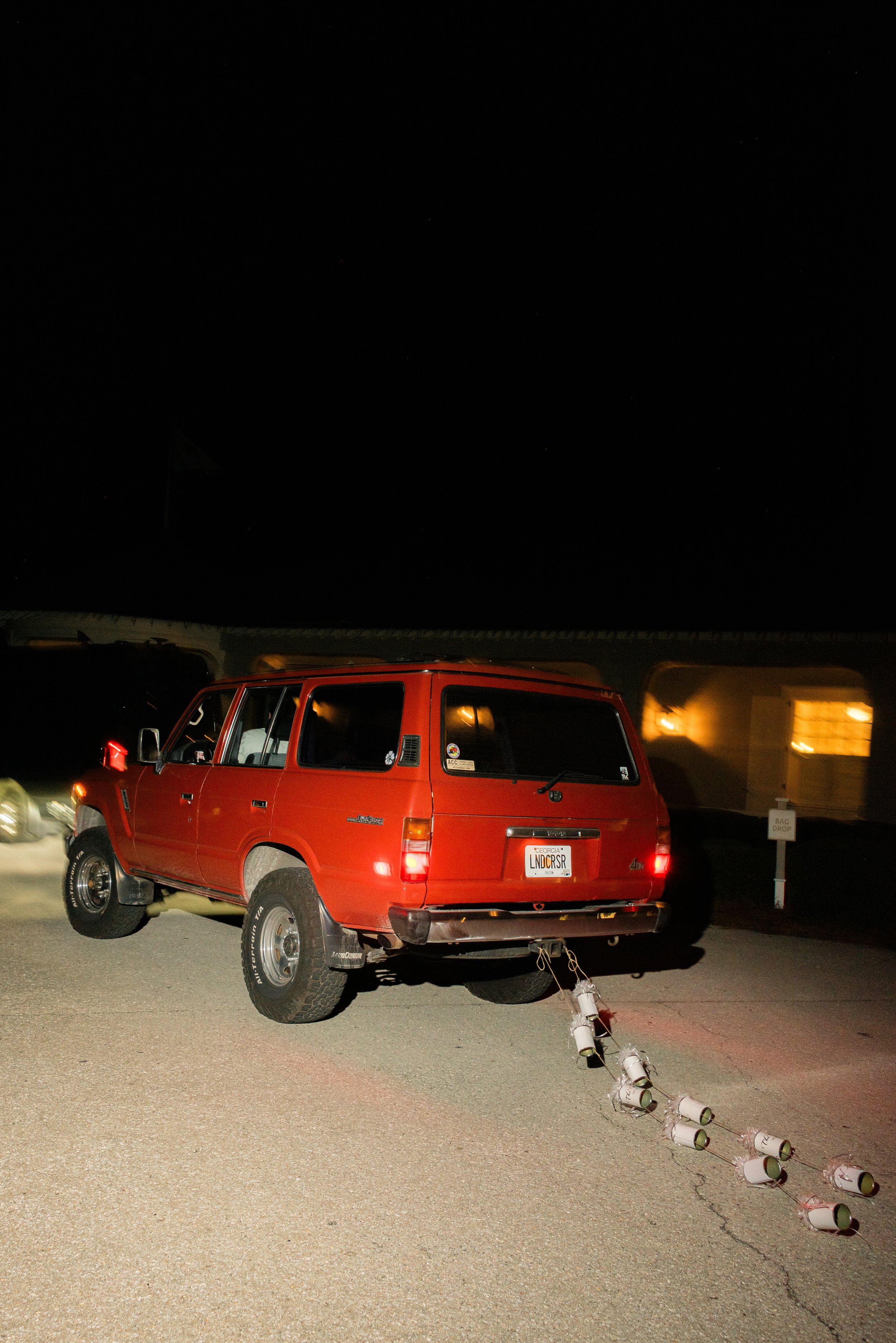 Vintage red Ford Bronco waits outside at night for Katie and Trevor’s departure from The Ocean Course.