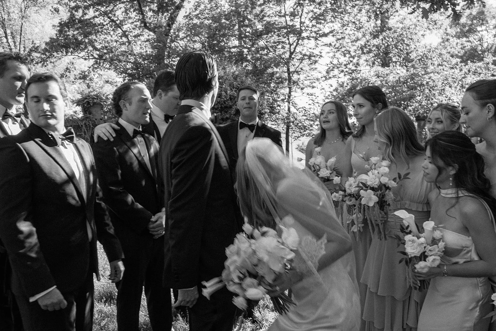 Black-and-white candid of wedding guests and the bridal party gathering before the ceremony at Goodstone Inn.