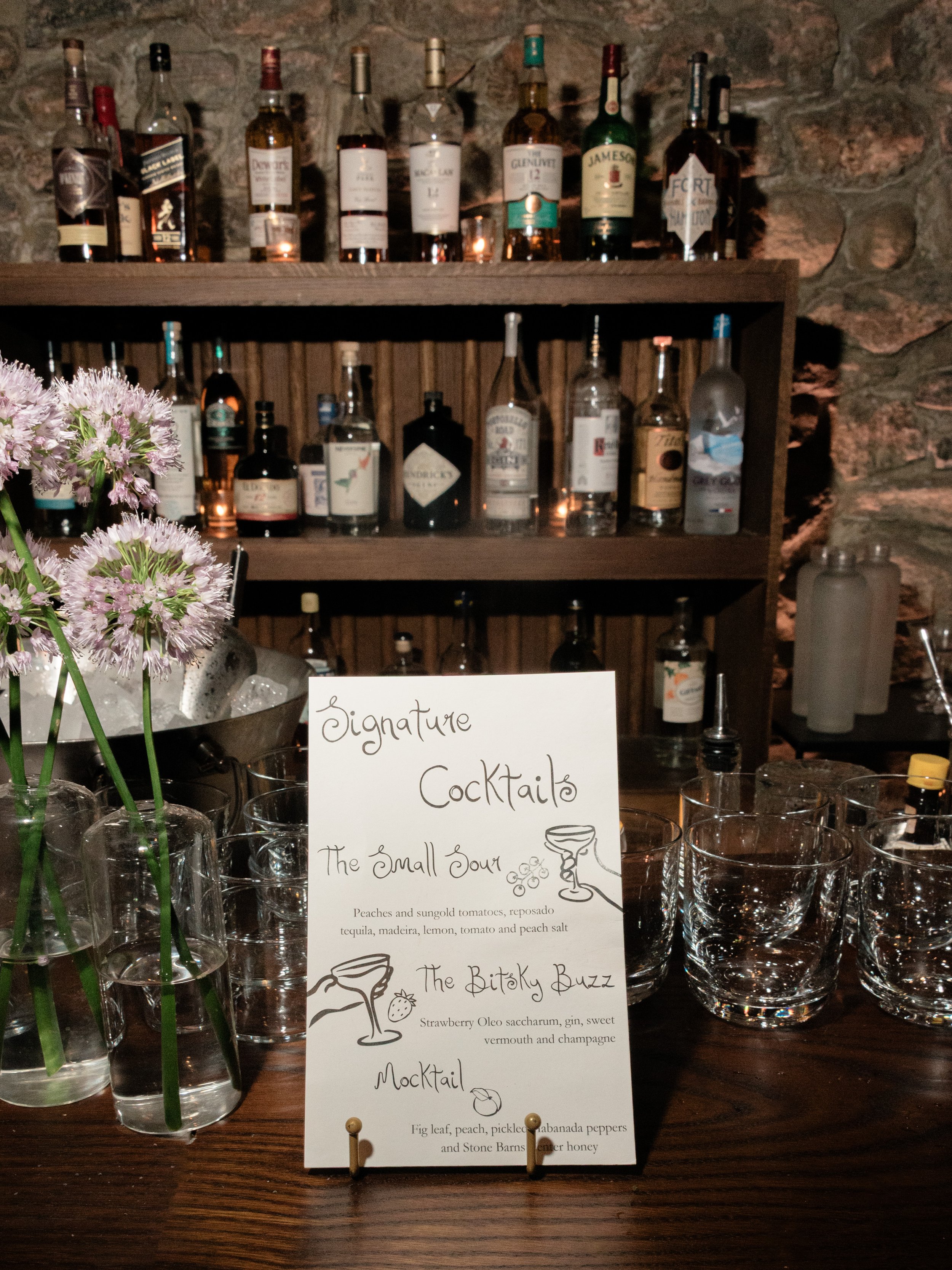 Handwritten font style signature cocktail menu displayed at the reception bar inside Blue Hill at Stone Barns.
