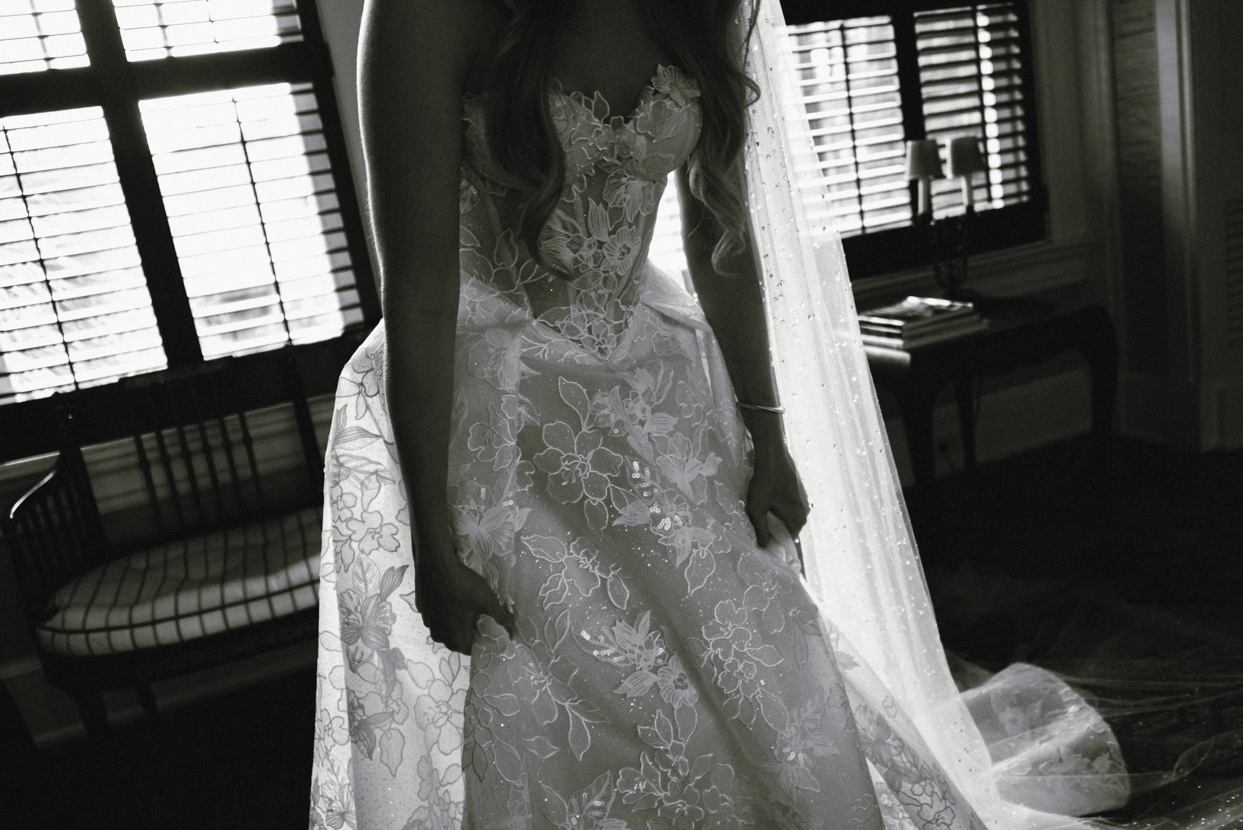 Black-and-white close-up of the floral lace and sculpted bodice of Katie’s Galia Lahav wedding gown.