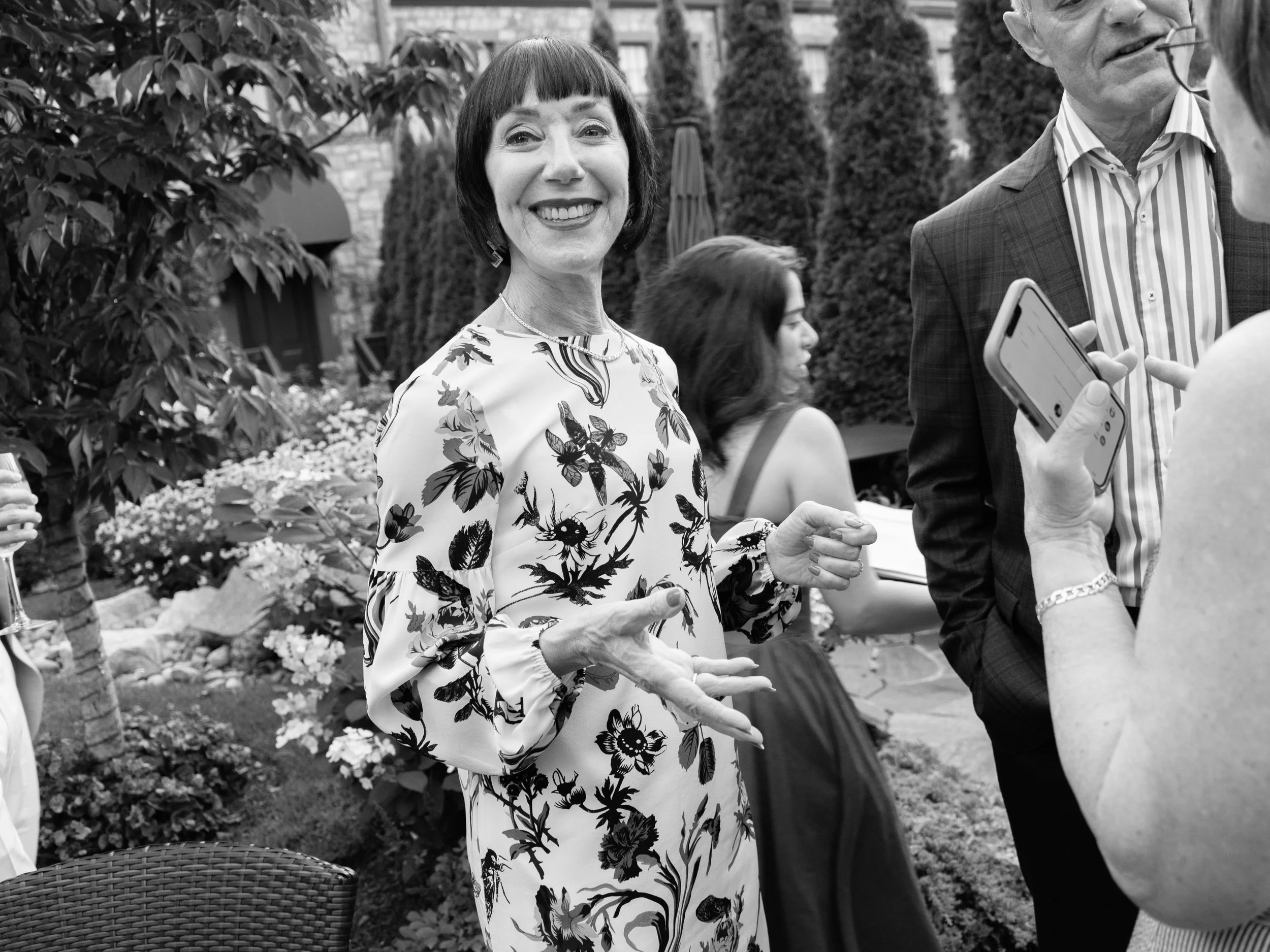 Black-and-white candid of a smiling guest outside The Abbey Inn & Spa.