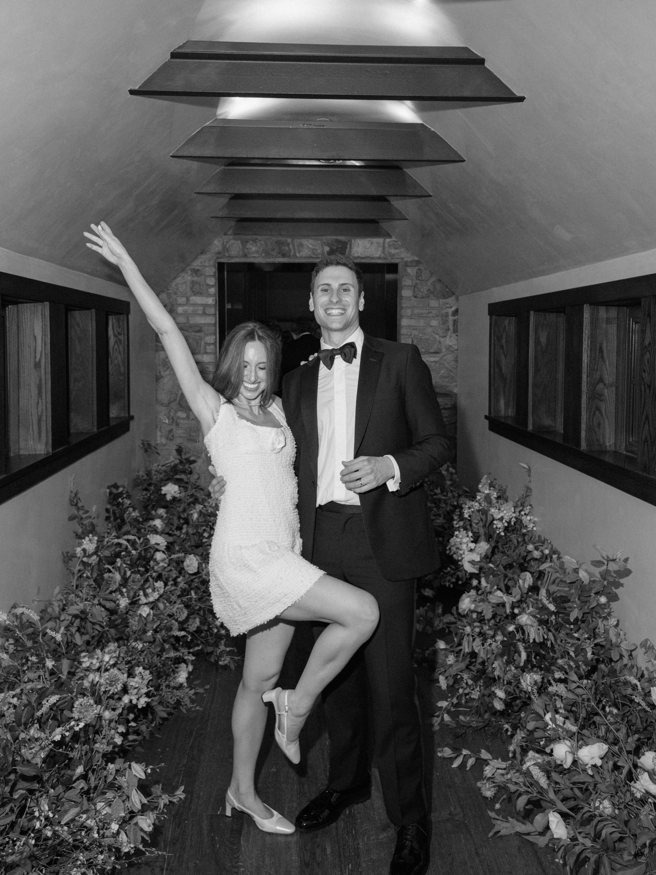 Black-and-white reception portrait of Jennie in her vintage Chanel mini dress during the evening celebration.