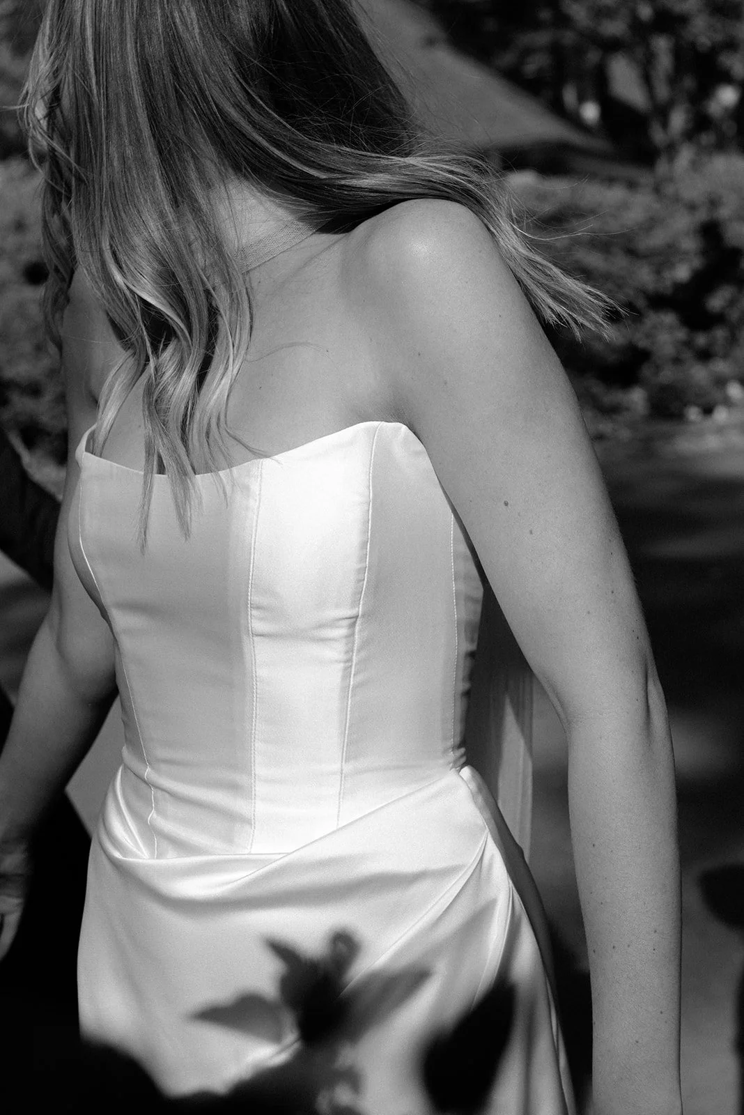 Black-and-white close-up of the bride’s satin gown with shadow play during portraits at Goodstone Inn.