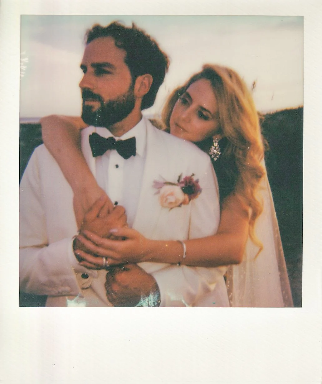 Instant-film portrait of Katie embracing Trevor during golden hour on Kiawah Island.