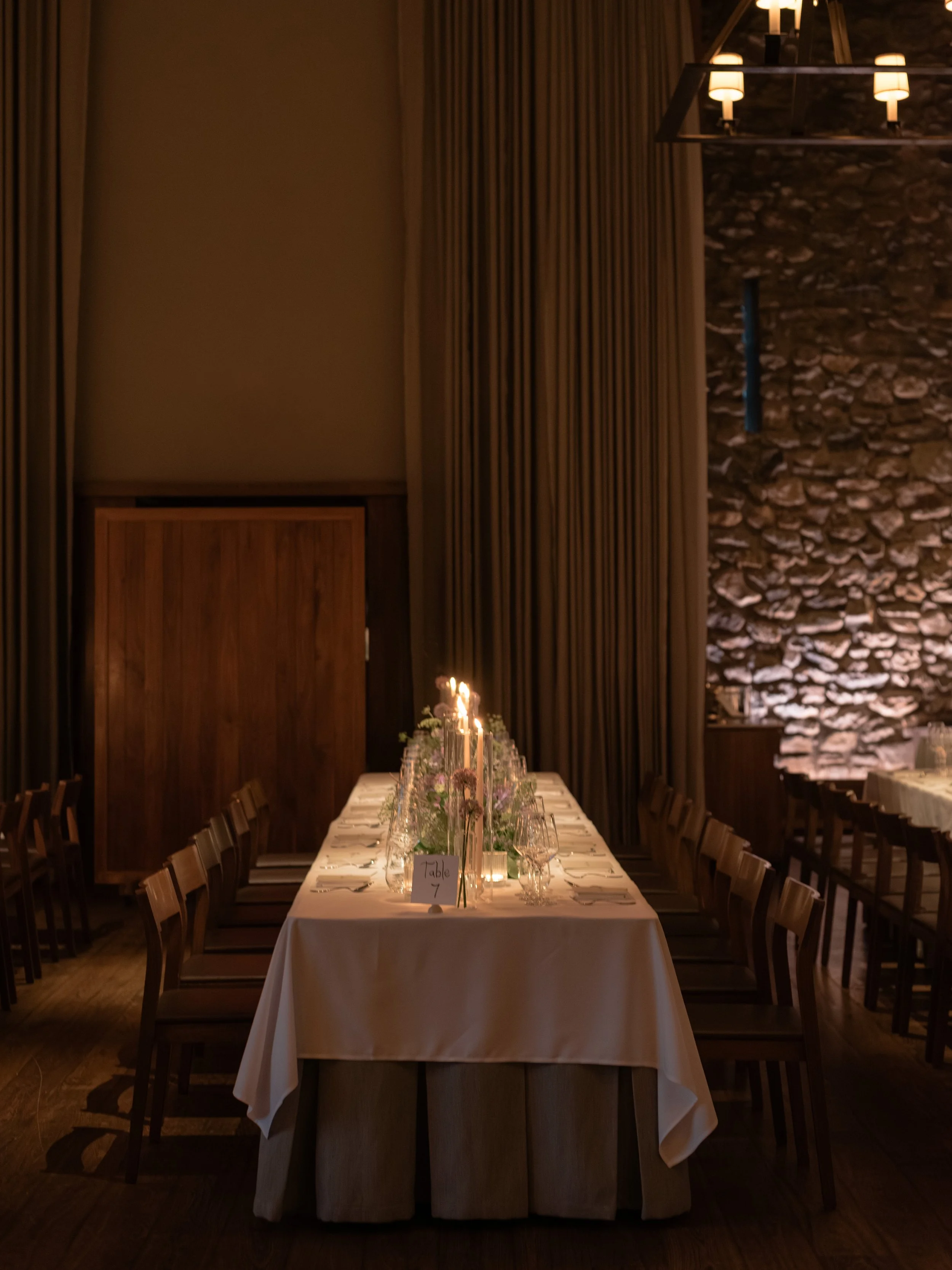 Intimate candlelit dinner table inside Blue Hill at Stone Barns before guests were seated.