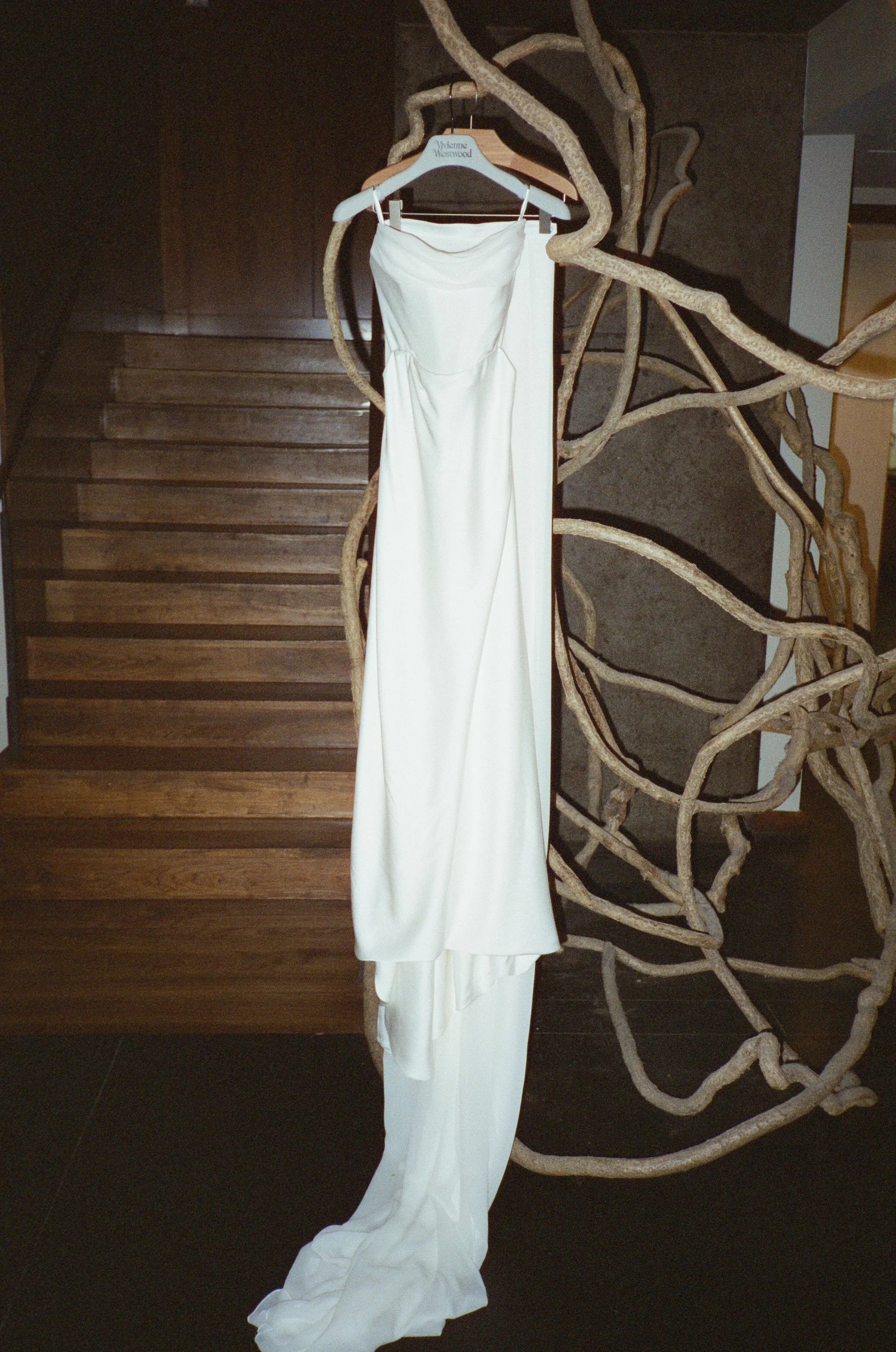 Vivienne Westwood wedding gown hanging before a luxury wedding at Blue Hill at Stone Barns photographed on 35mm Cinestill 400d film. 