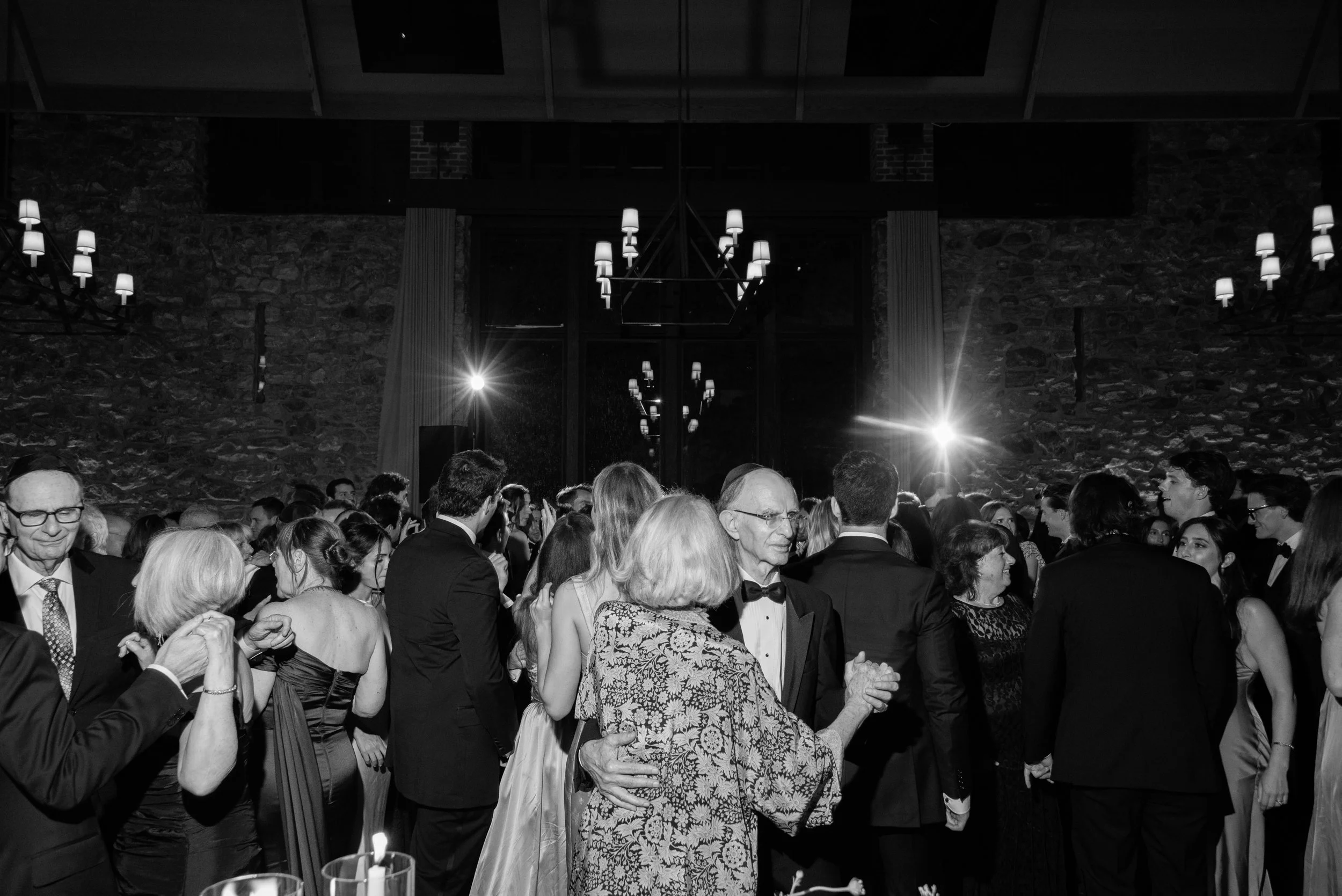 Black-and-white documentary photograph of a packed dance floor during the Blue Hill wedding reception.