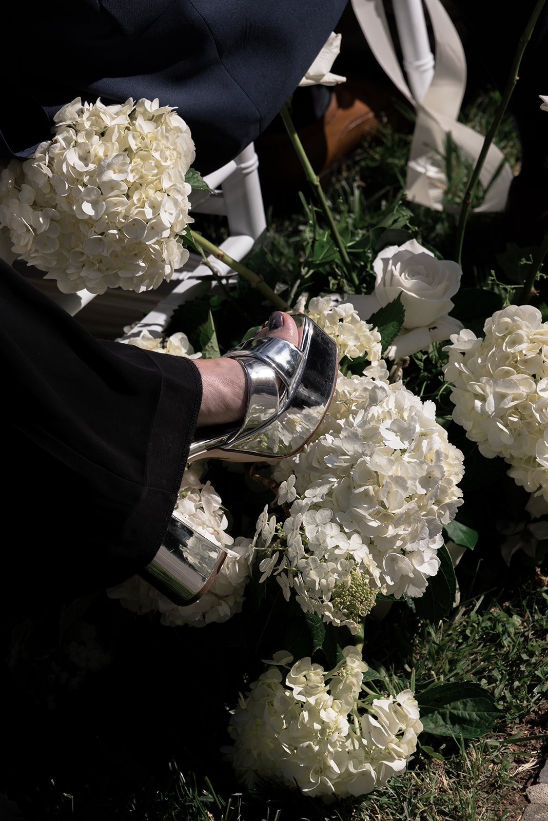 Close view of abundant white hydrangeas and garden flowers beside the ceremony aisle at Goodstone Inn.
