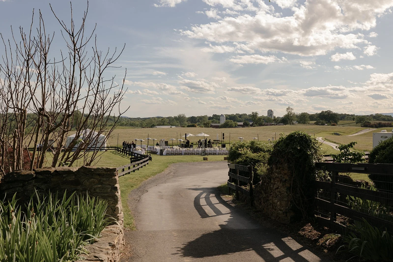 View across the winding drive and rolling countryside at Goodstone Inn beneath a dramatic spring sky.