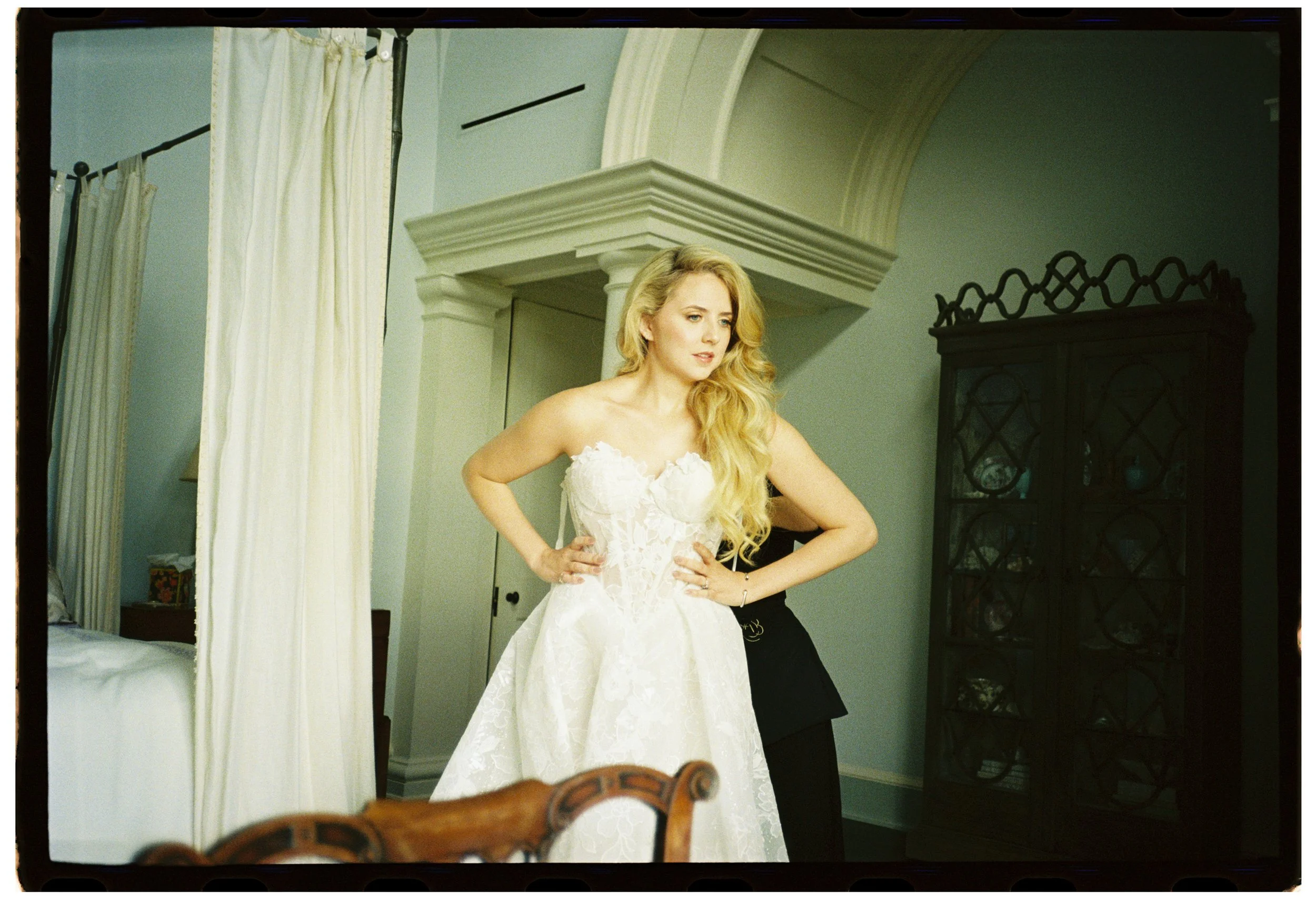 The bride steps into her lace Galia Lahav wedding gown inside the private Kiawah Island estate before the ceremony, photographed on 35mm film.