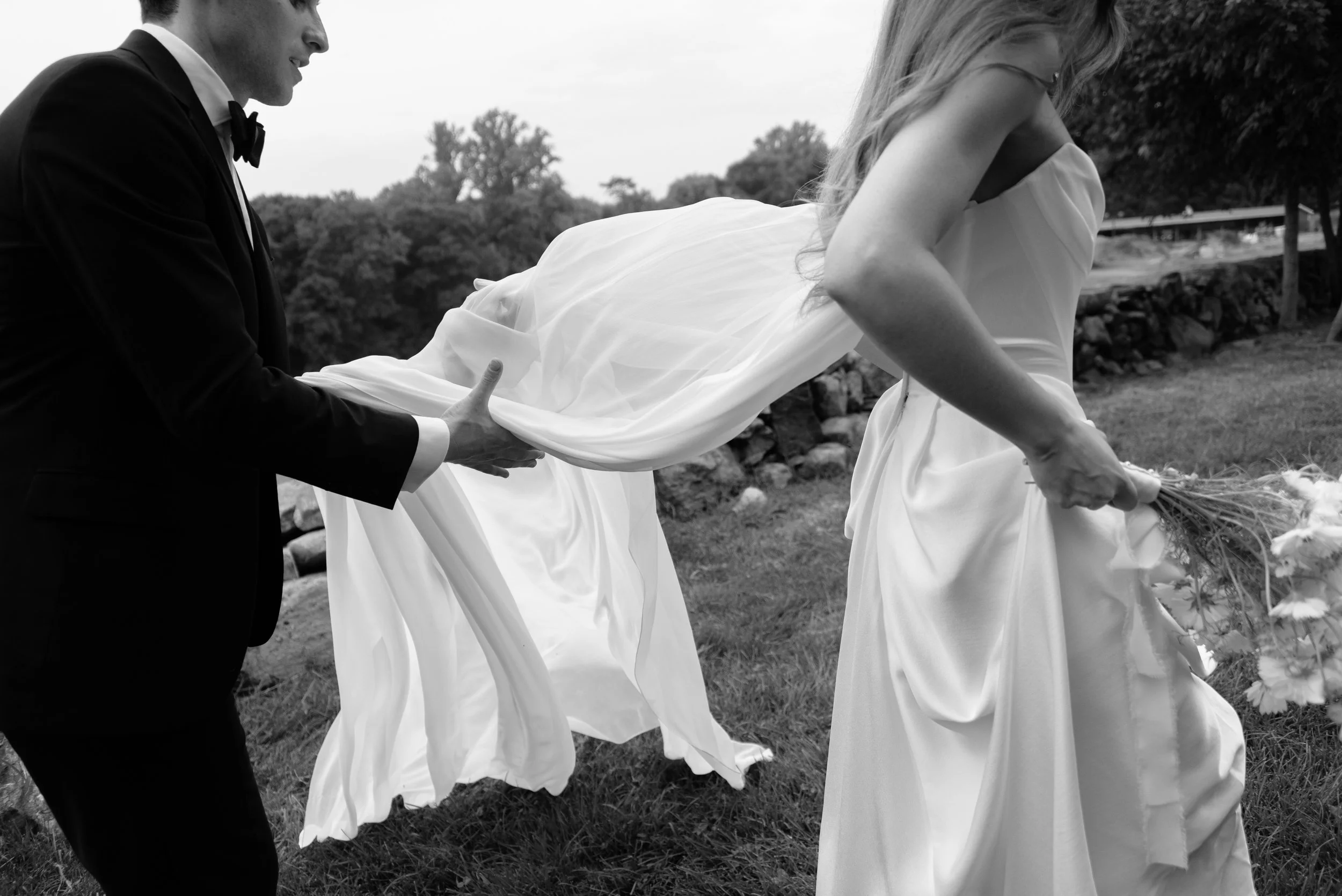 The groom attempts to hold the bride's Vivienne Westwood Galaxy cape.