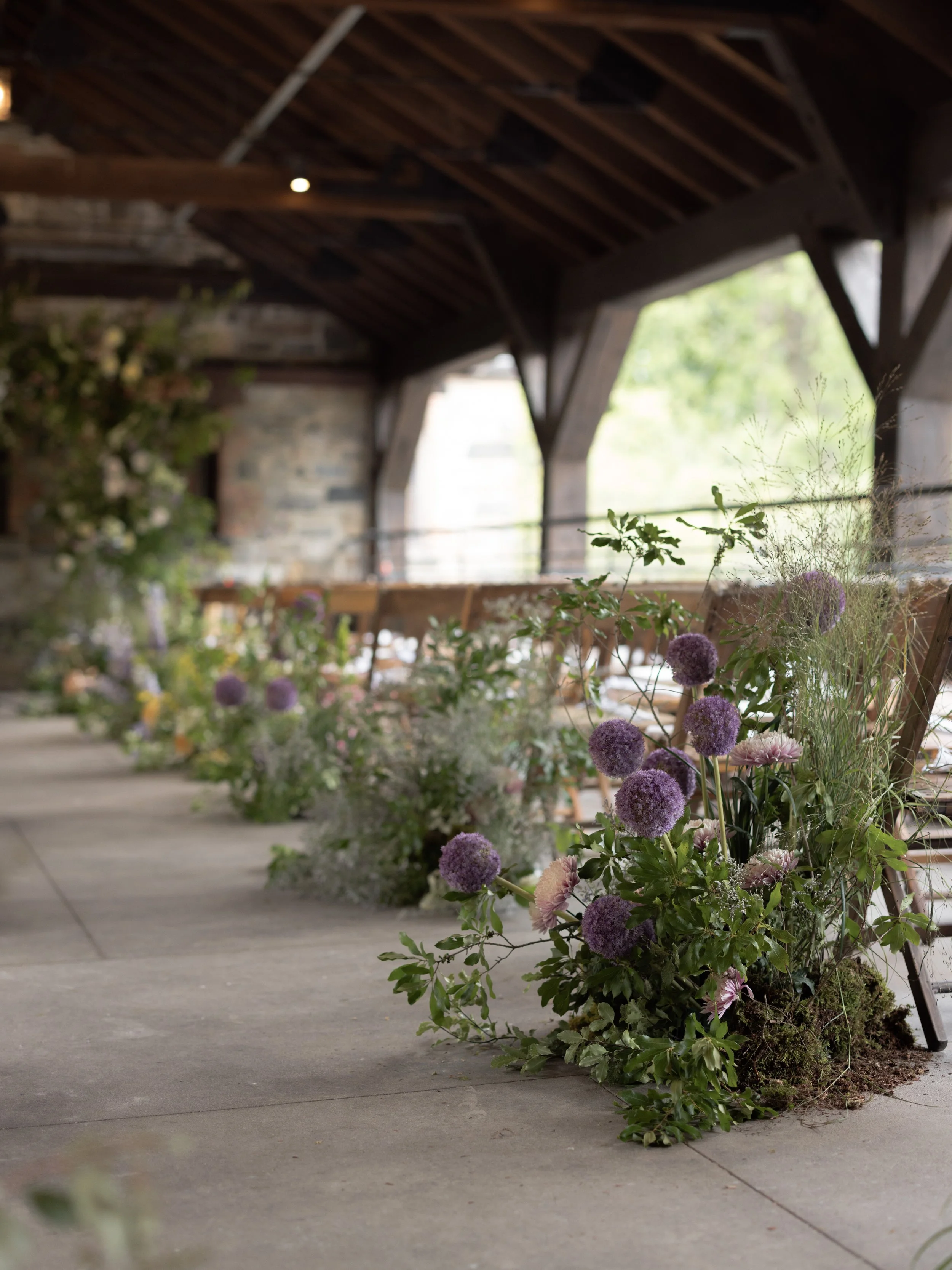 A rain plan ceremony beneath the pergola at Blue Hill at Stone Barns transformed into an intimate luxury wedding setting with florals by Wild and Birch out of New York City.