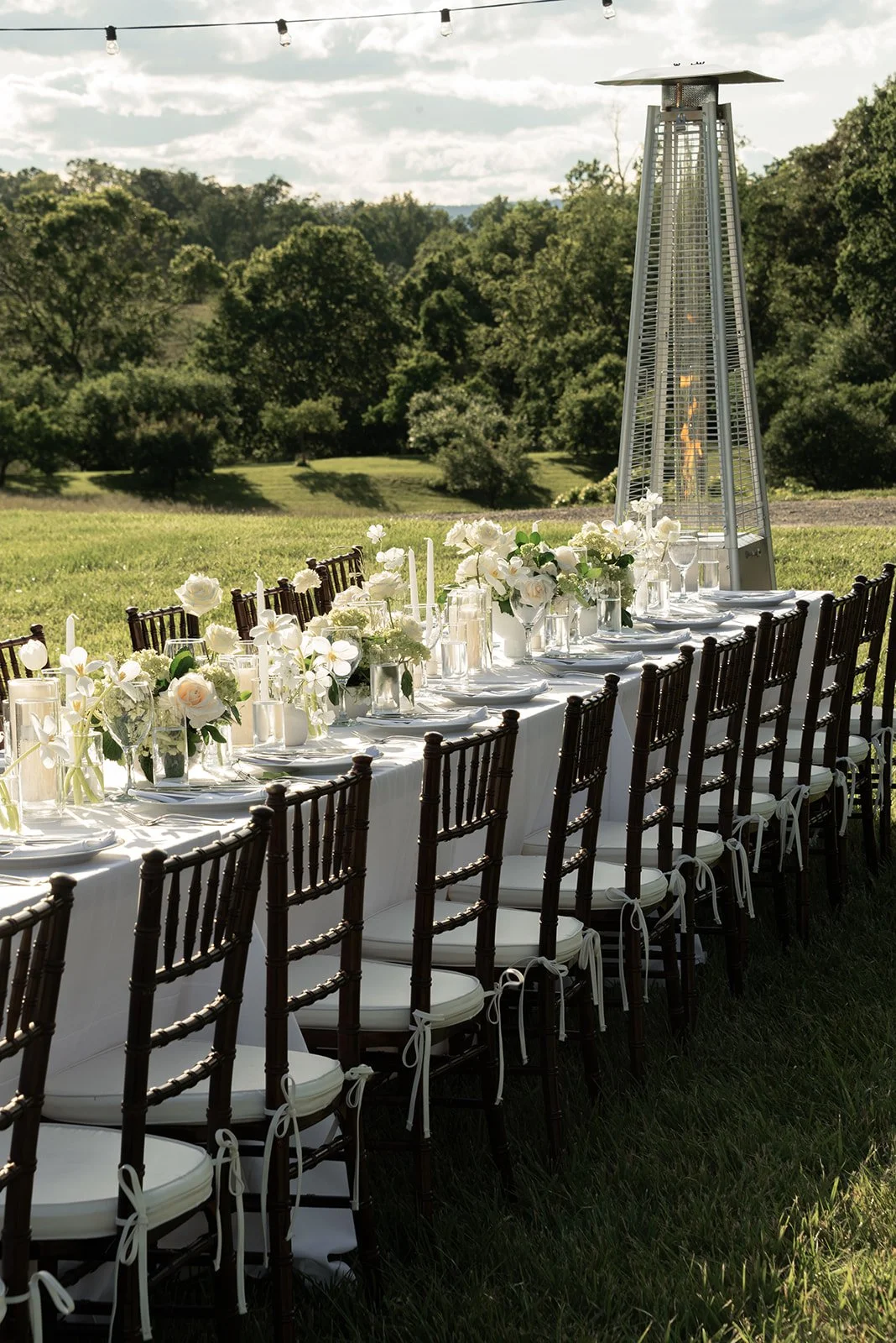 Long outdoor reception tables arranged across the Hayfield at Goodstone Inn with Virginia countryside views beyond.