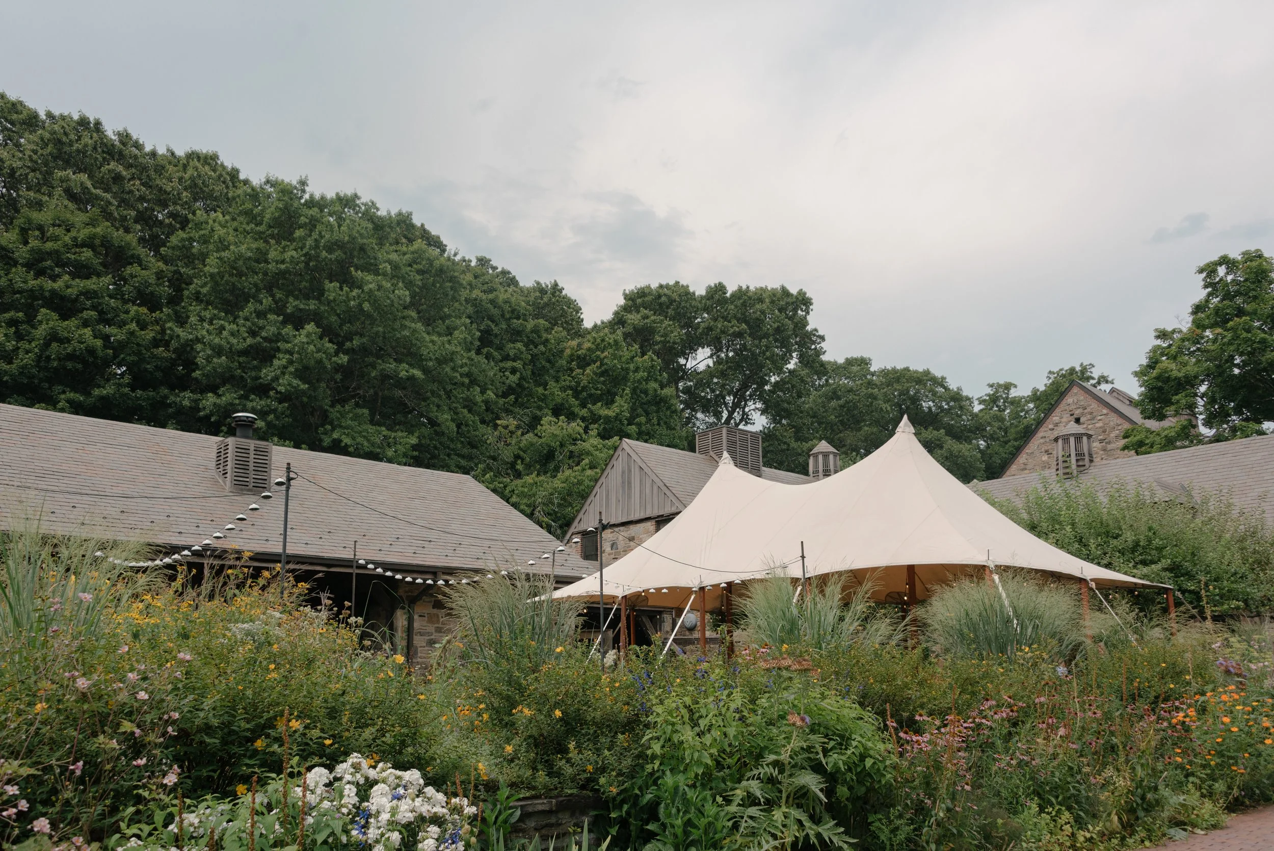 Natural floral textures and wild gardens reflect the organic beauty of a Hudson Valley wedding venue.