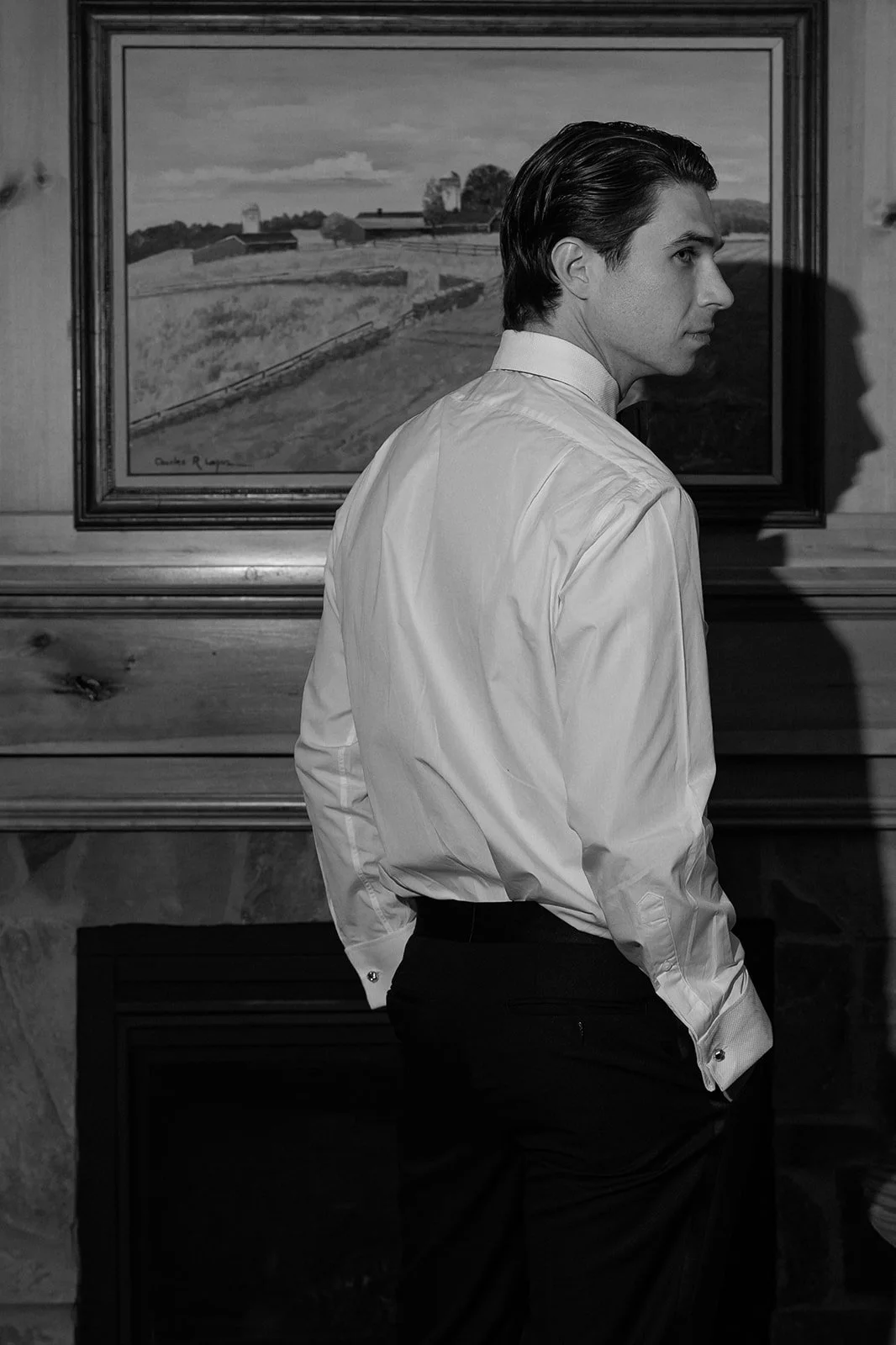 Black-and-white flash portrait of groom inside the Spring House at Goodstone Inn.