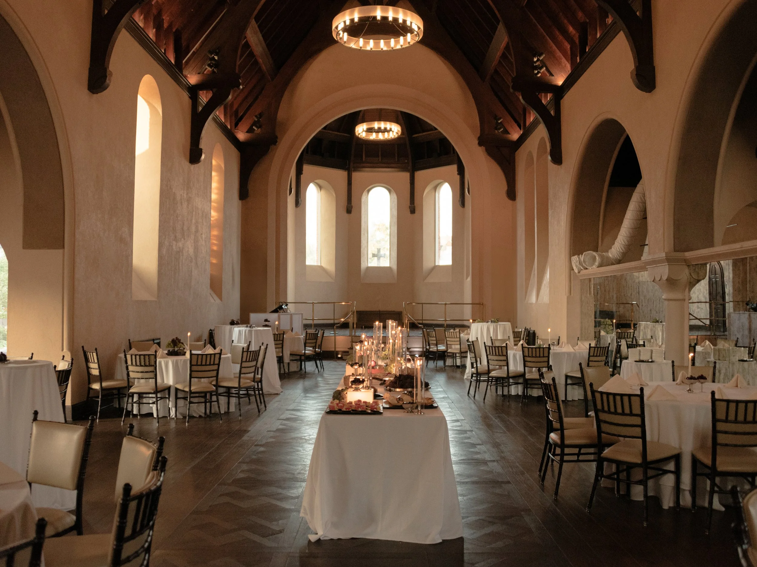 Wide view of the historic dining room and long candlelit table at The Abbey Inn & Spa.
