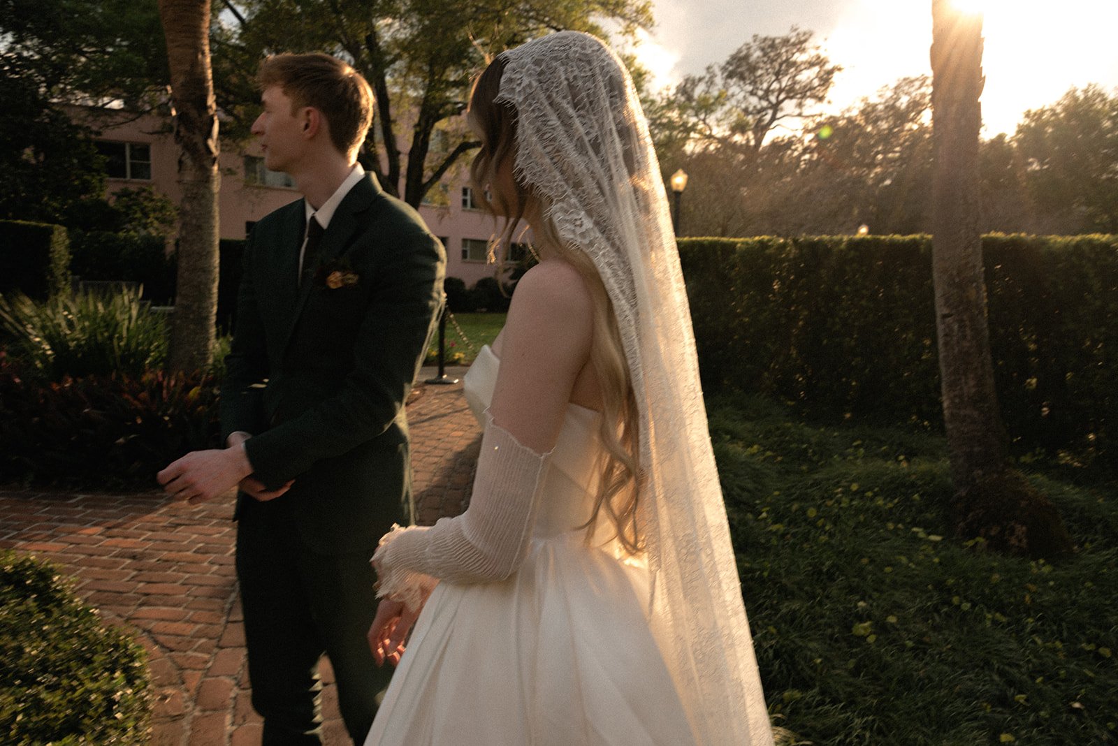 Bride and groom standing together during a golden hour wedding portrait at Casa Feliz in Winter Park, Florida, with soft evening light and an editorial documentary photography approach.