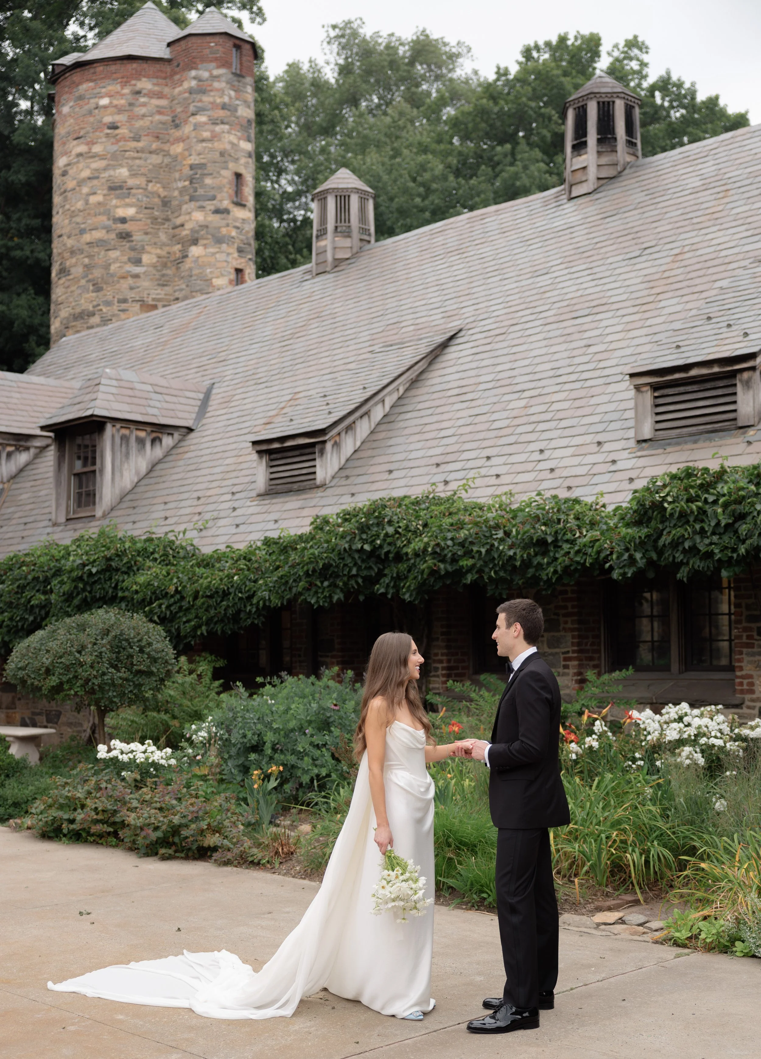 Bride holding a delicate floral bouquet during her Blue Hill at Stone Barns wedding portraits.