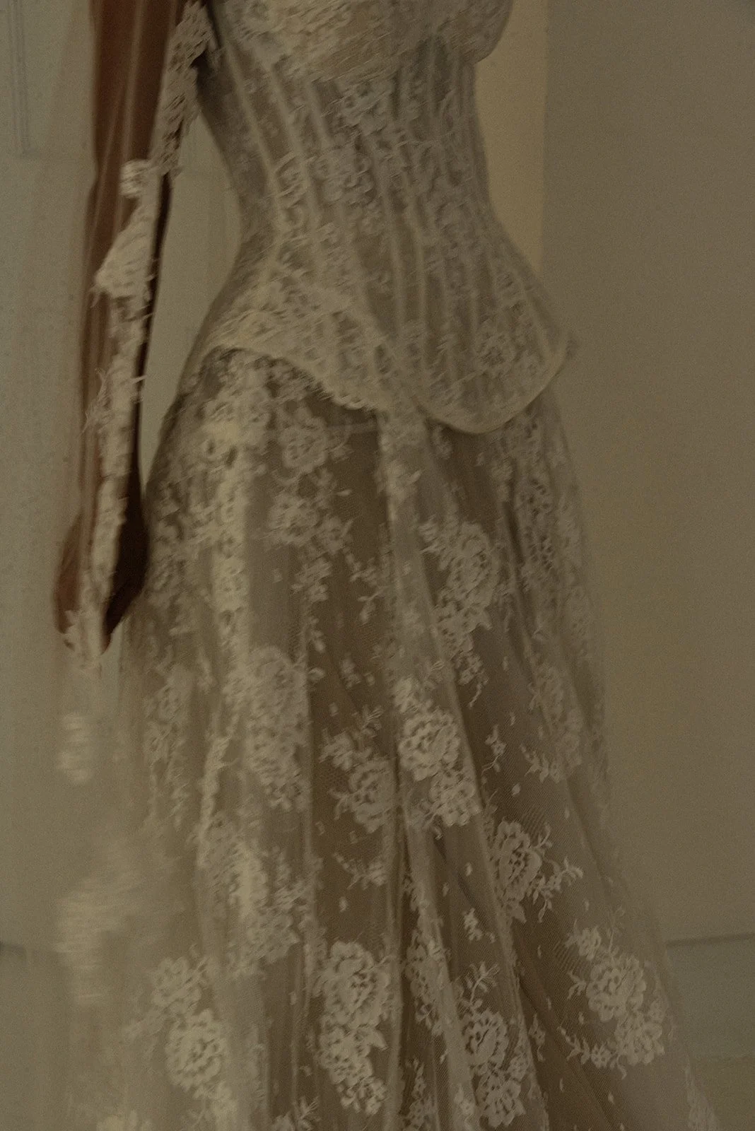 Close-up photograph of a bride’s lace wedding gown designed by Milla Nova, highlighting intricate texture, craftsmanship, and timeless bridal fashion details.