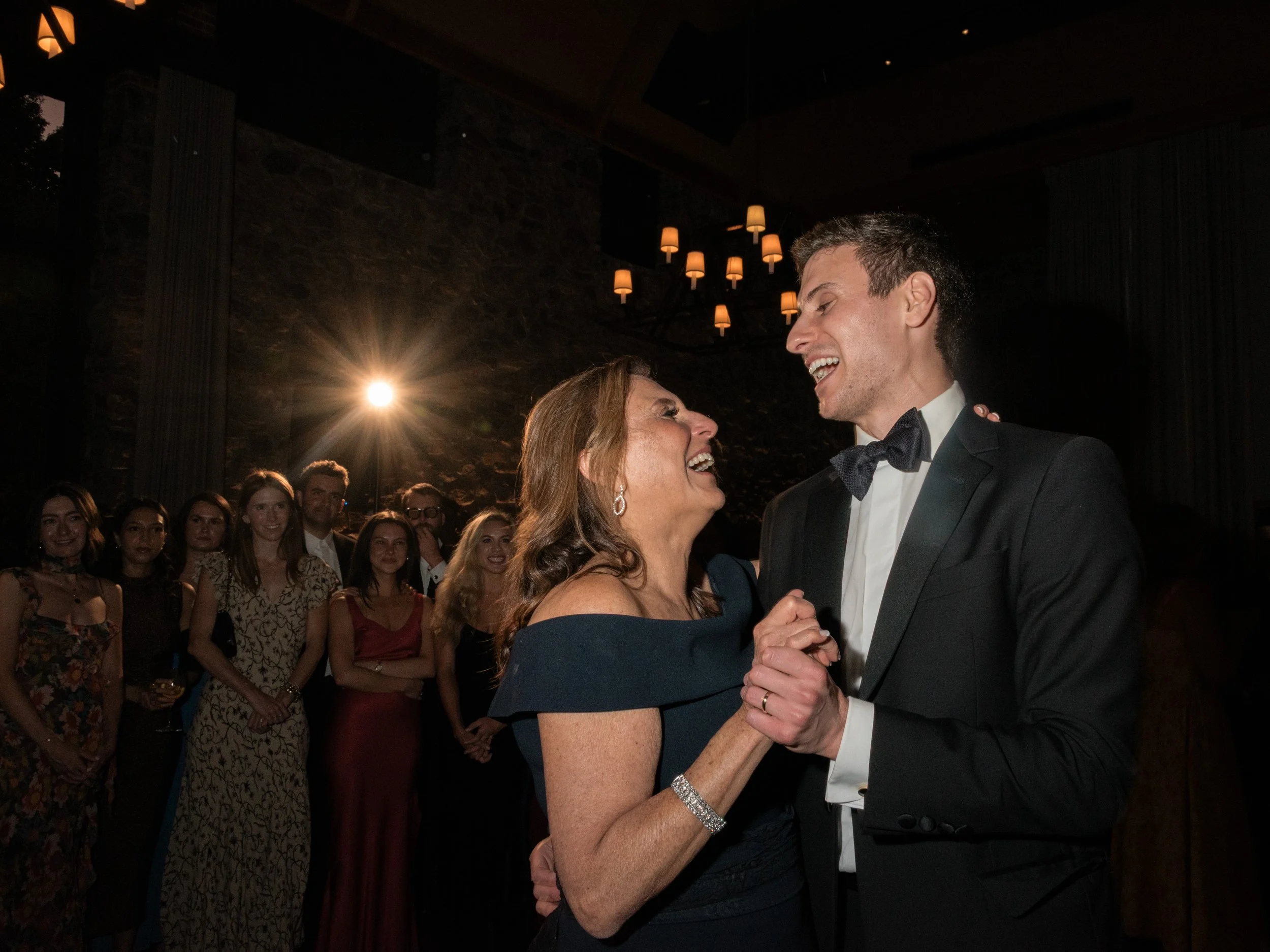 The mother of the groom and the groom share their formal dance.