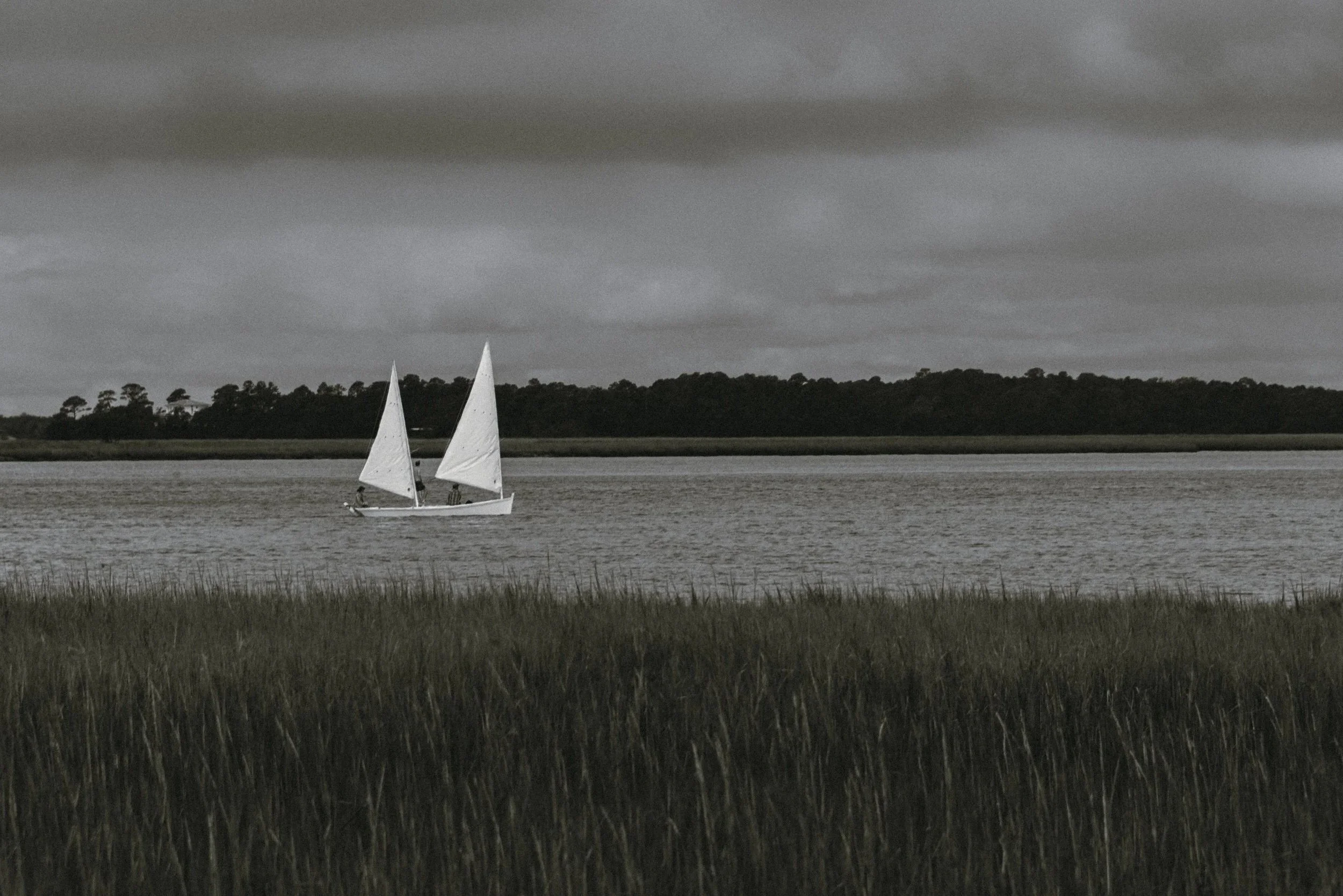 Two sailboats cross the marsh beside the private Kiawah Island estate where Katie and Trevor prepared for their wedding day.
