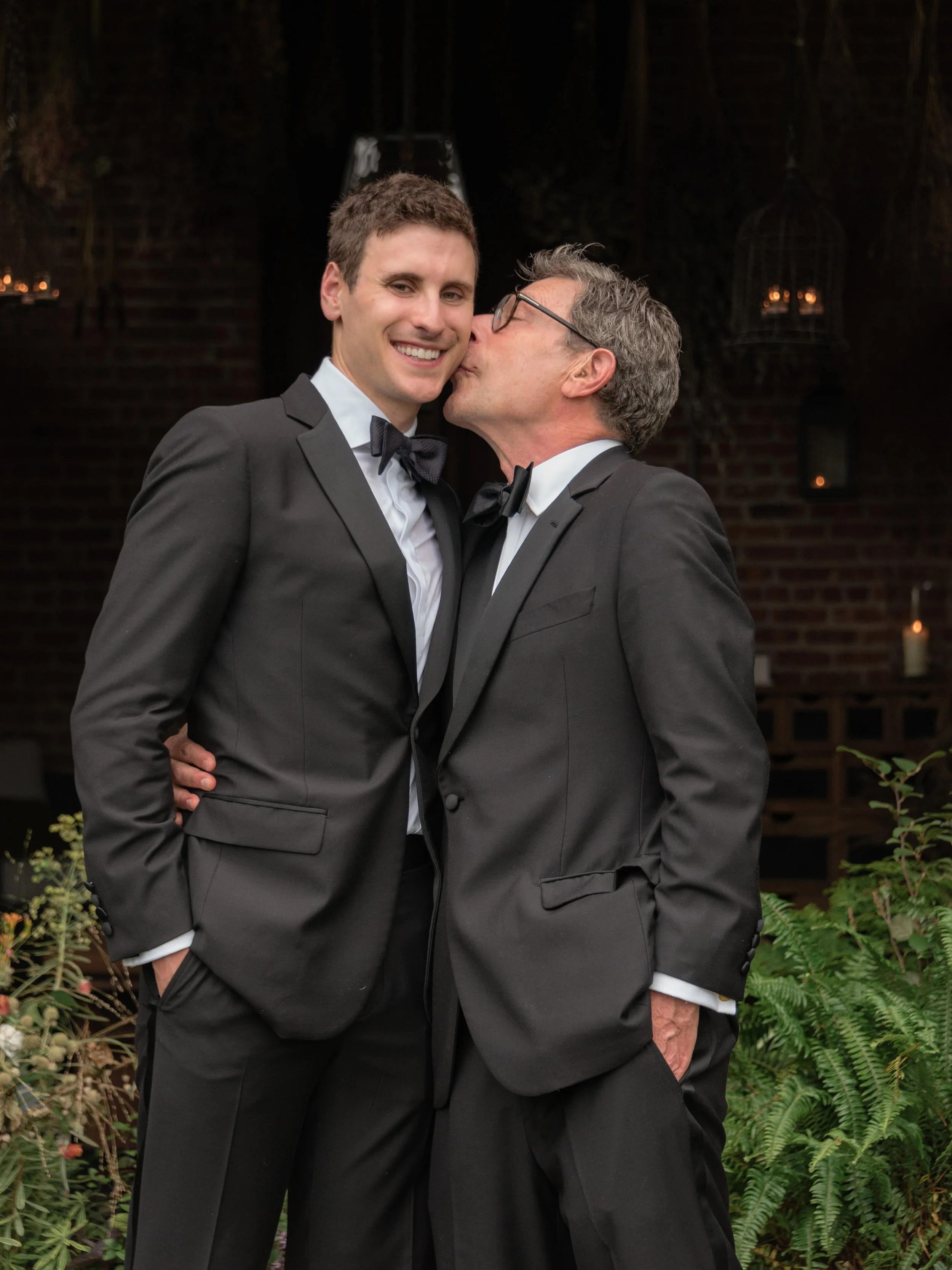 Will shares an affectionate moment with his father during wedding-day family portraits at Blue Hill at Stone Barns.