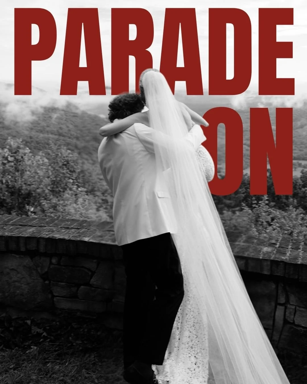 Editorial black and white wedding portrait of a bride with a flowing veil against a “Parade On” backdrop, blending fashion imagery with unexpected visual storytelling.
