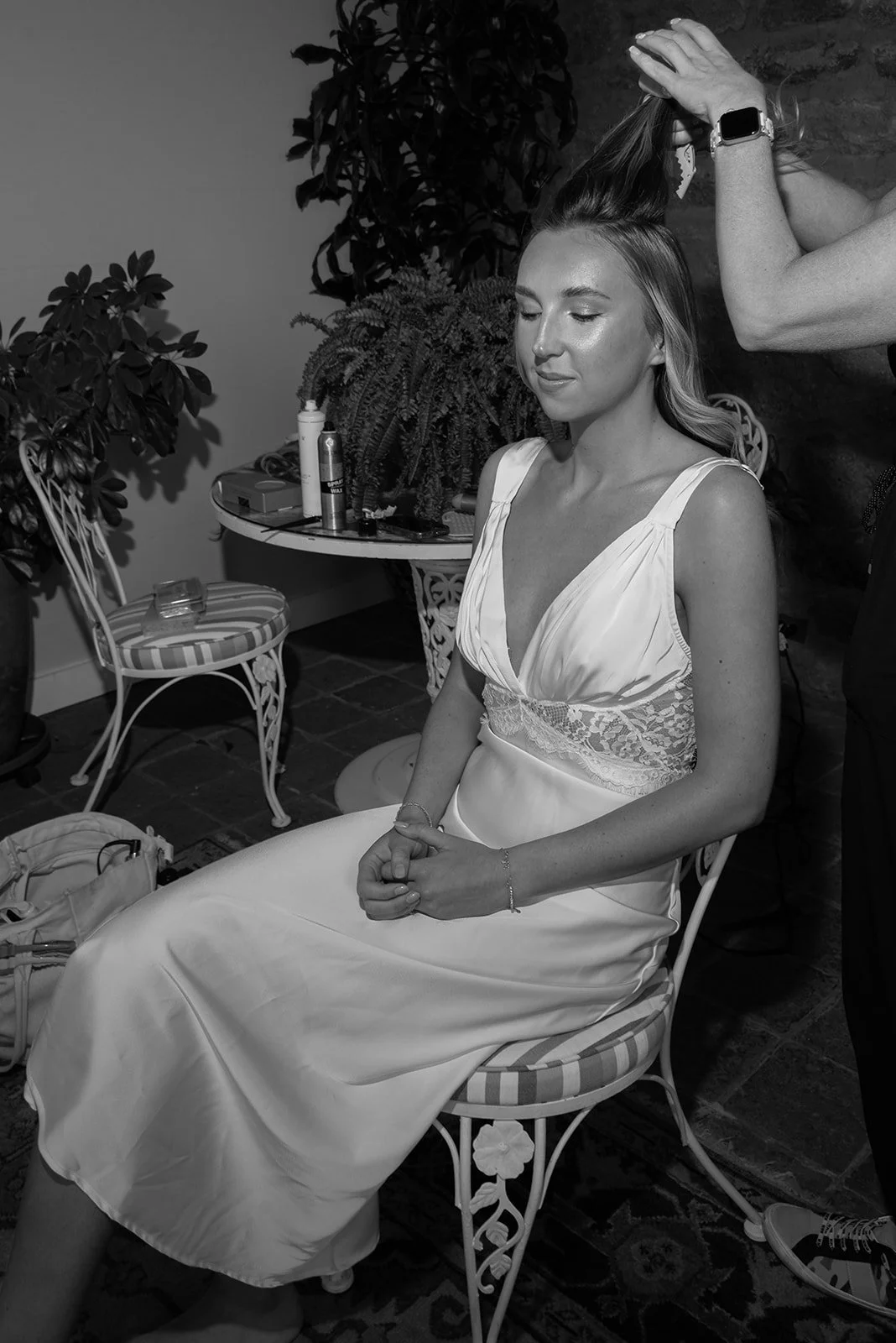 Black-and-white candid portrait of a bridesmaid during wedding-day preparations at Goodstone Inn.