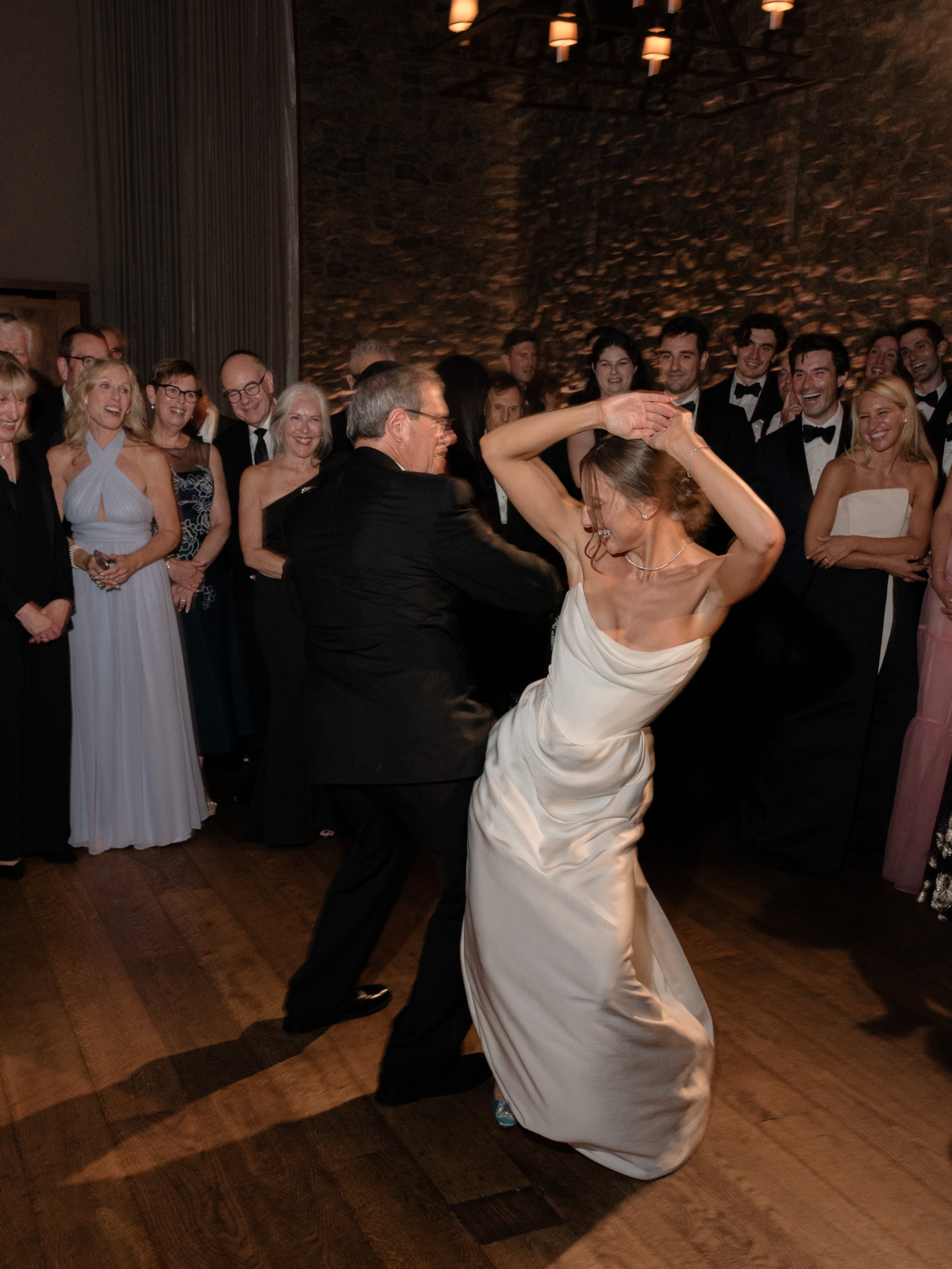 The bride and her father dance the dance from Parent Trap for their formal dance together during the wedding reception. 