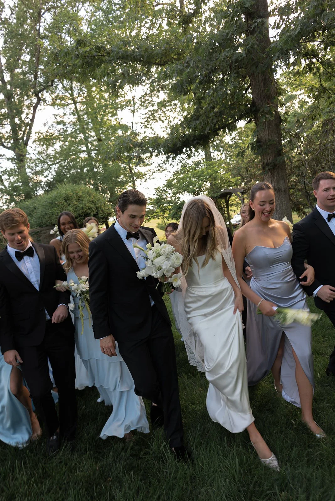 Wedding party in colorful formal wear gathered outdoors at Goodstone Inn.