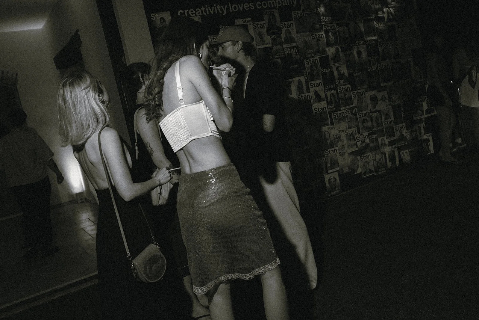 Black and white documentary photograph of guests dancing and celebrating at an evening event in Cannes, France, capturing movement, energy, and the atmosphere of a gathering.