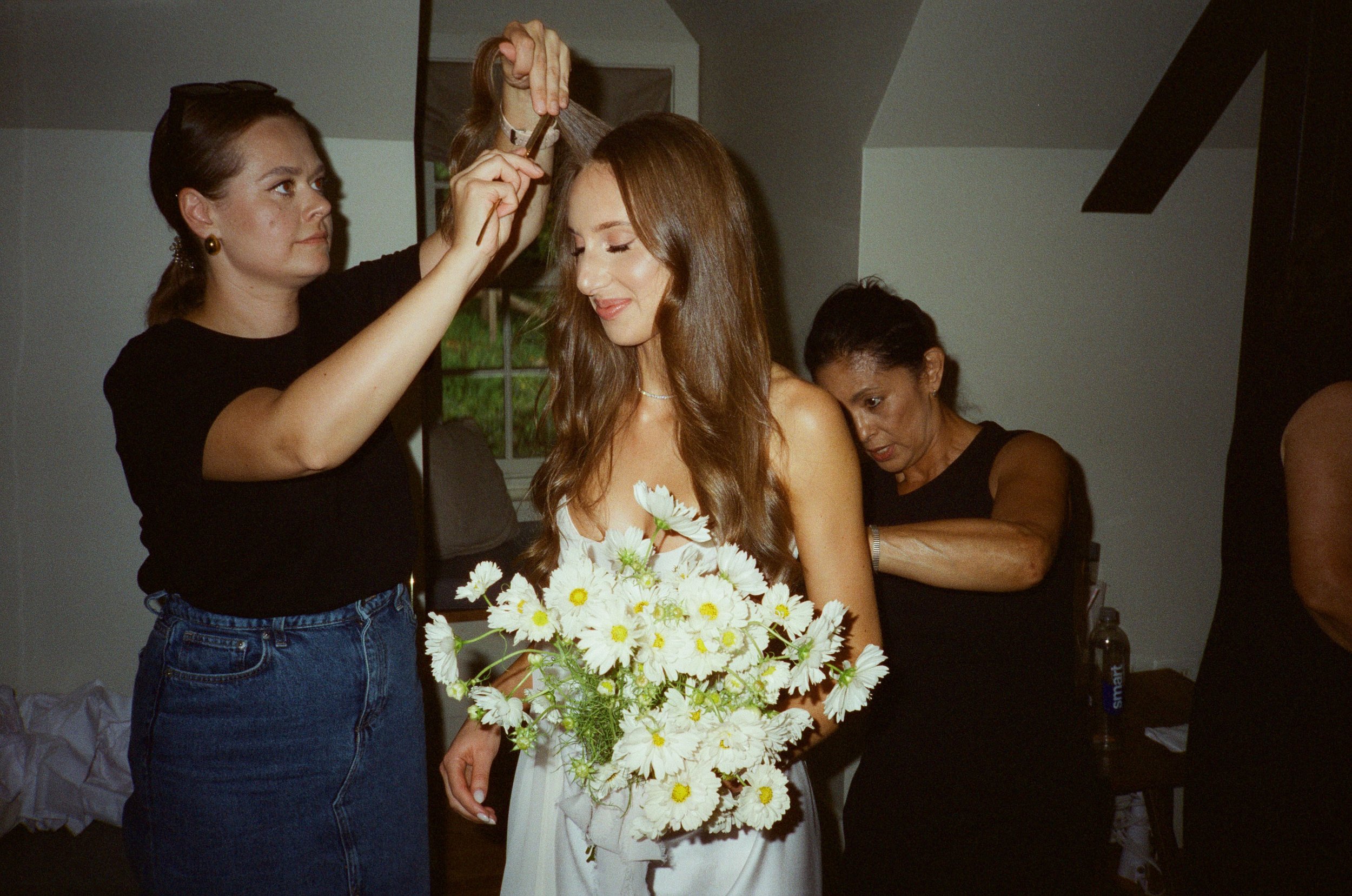 Bride gets ready with HMUA and onsite Bridal Attendant in the bridal suite at Blue Hill at Stone Barns.