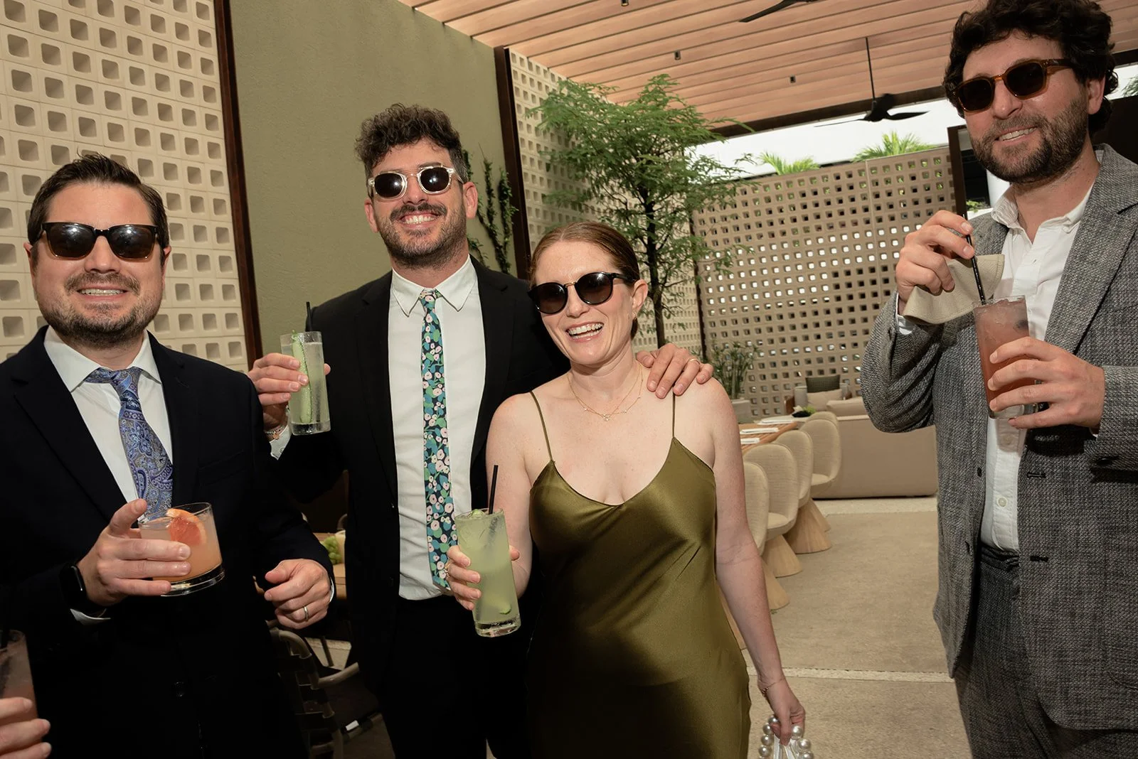 Candid portrait of wedding guests holding cocktails during the pre-ceremony celebration.