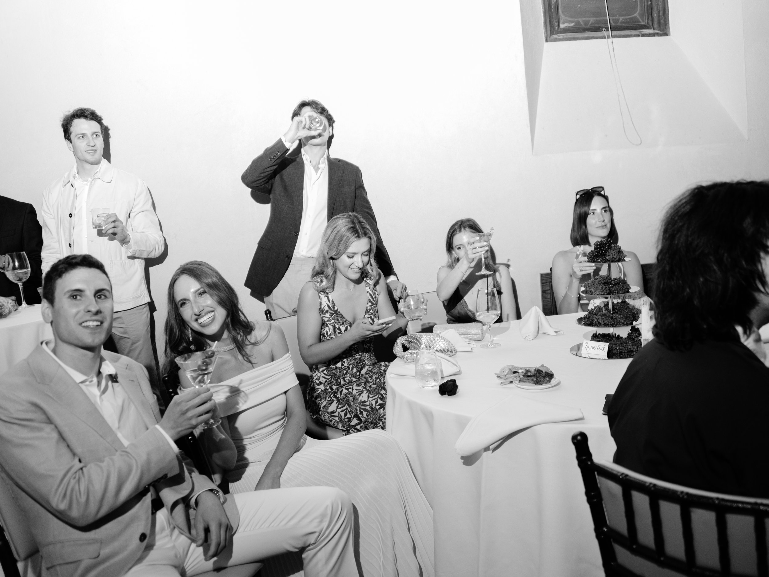 Black-and-white view of Jennie, Will and their guests listening to speeches around the dinner tables.