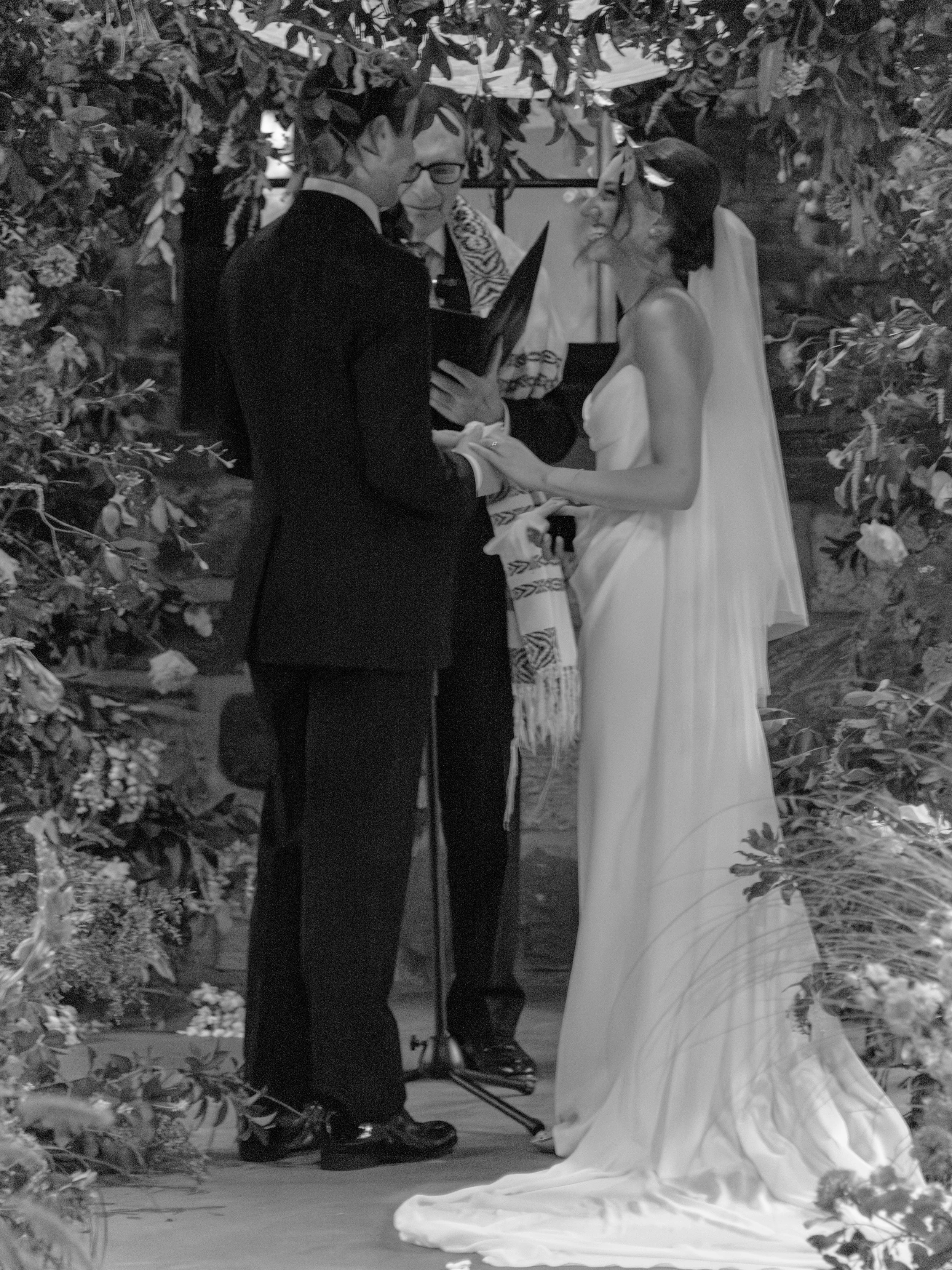 Jennie laughs at something Will says during his vows. 