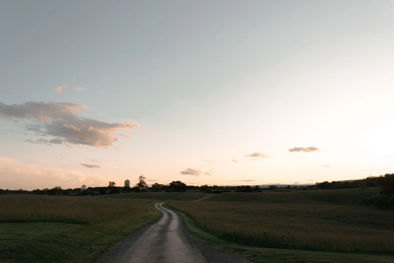 Country road stretching through the rolling landscape at sunset near Goodstone Inn in Middleburg, Virginia.