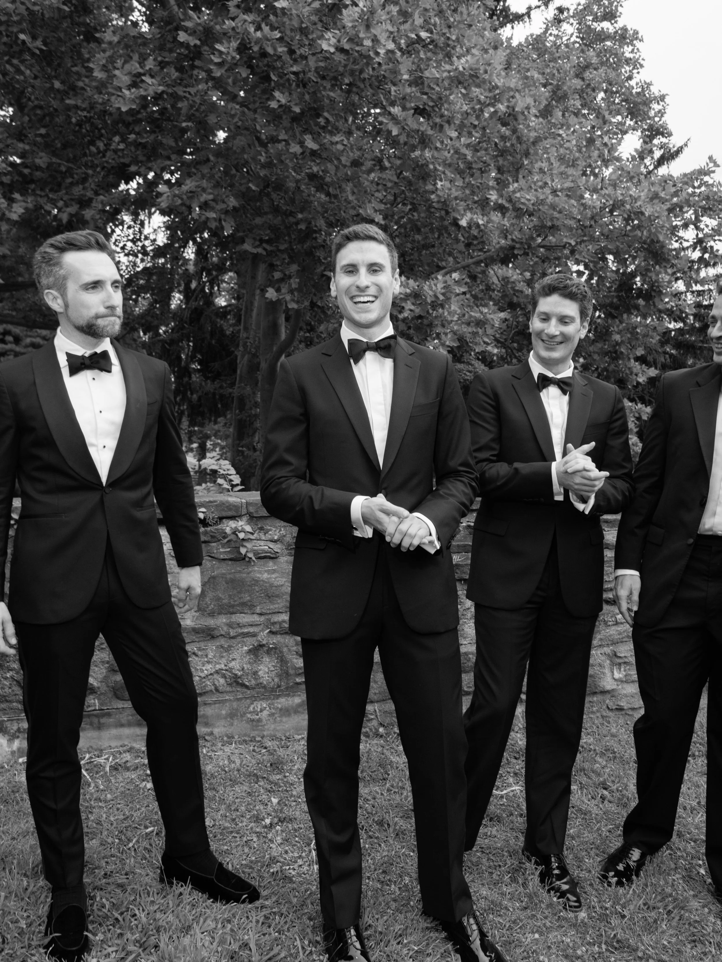 Will and his groomsmen pose together in black tie among the gardens of Blue Hill at Stone Barns.