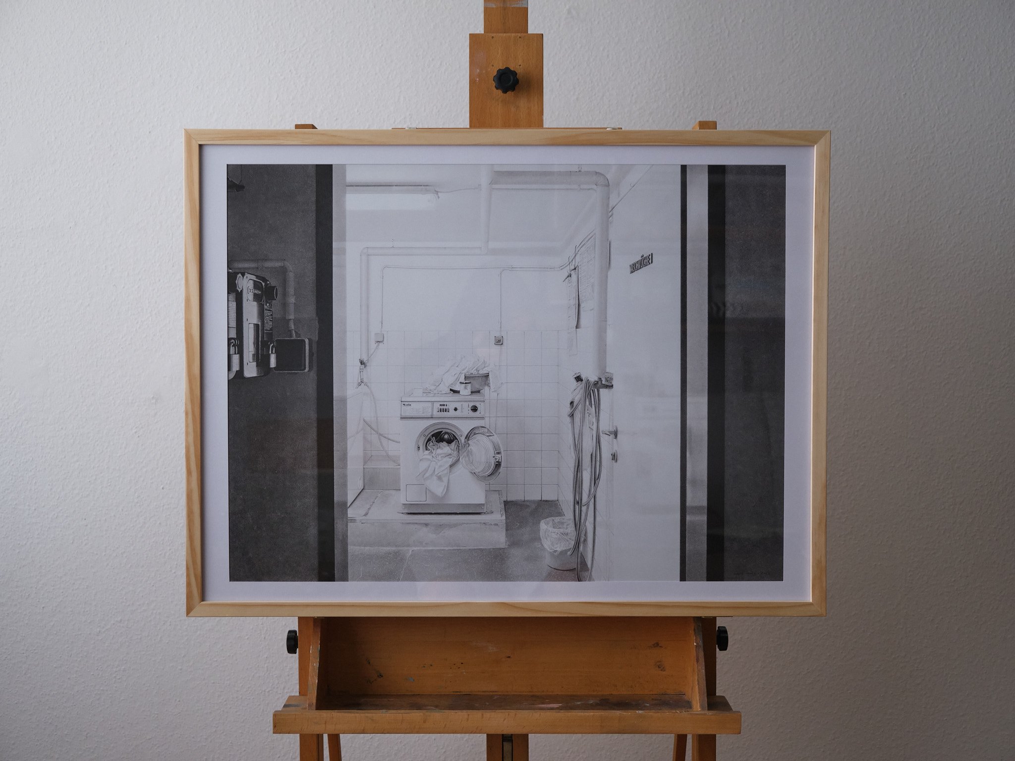 live view on framed art print hanged on easel in room
