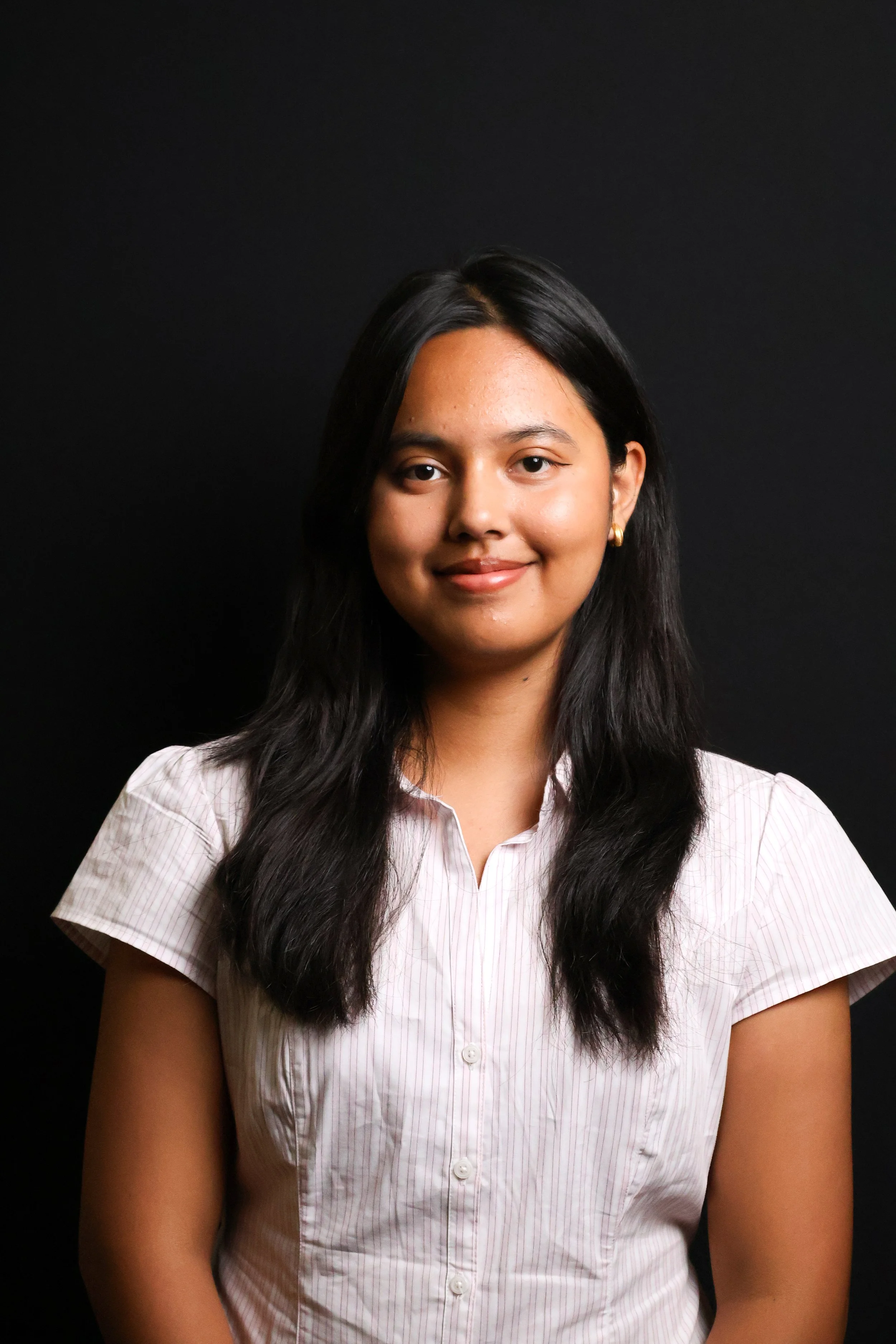 Professional headshot portrait by JSDFX Media of a college student against a black backdrop.