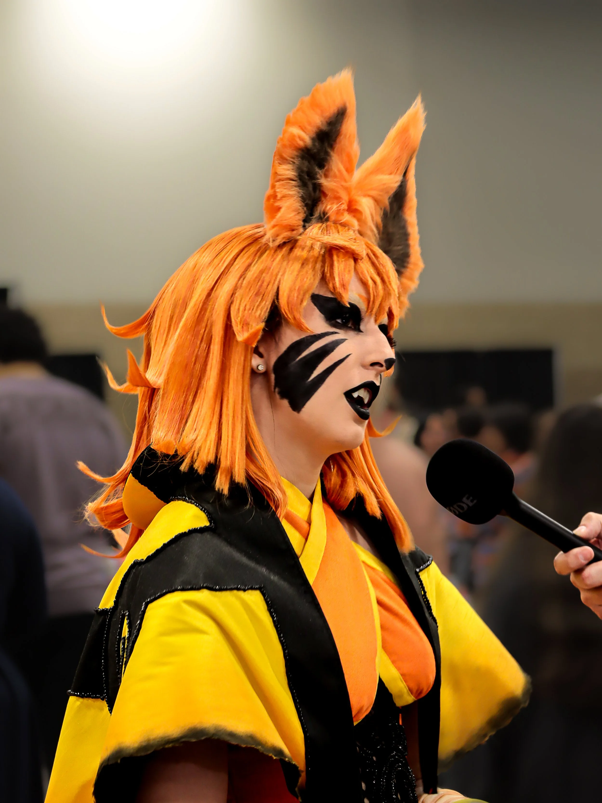 A female Kurama cosplayer from the show Naruto at Anime Frontier 2024 in Fort Worth, Texas
