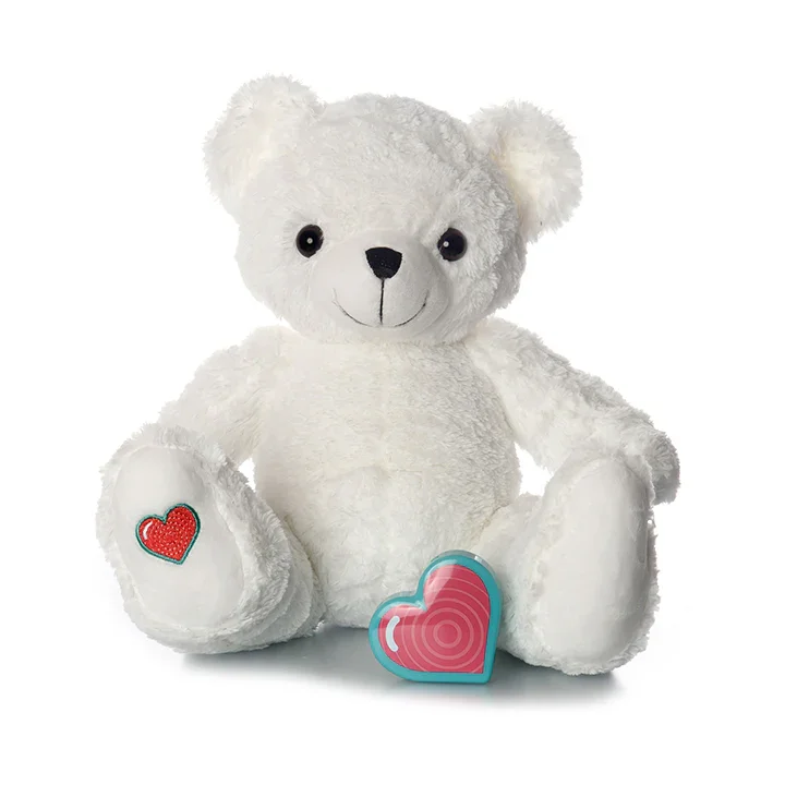 White teddy bear with heart-shaped object and smaller heart plush toy.