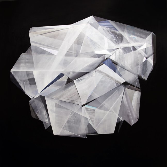 A transparent, geometric crystal sculpture with sharp edges and intersecting planes, set against a black background.