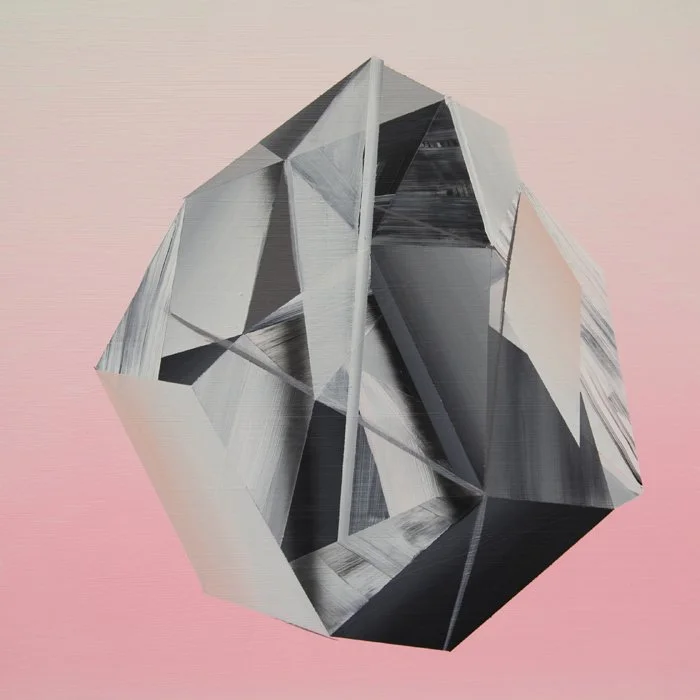 A geometric art piece featuring a large, three-dimensional, reflective, and faceted cube set against a pastel pink background.