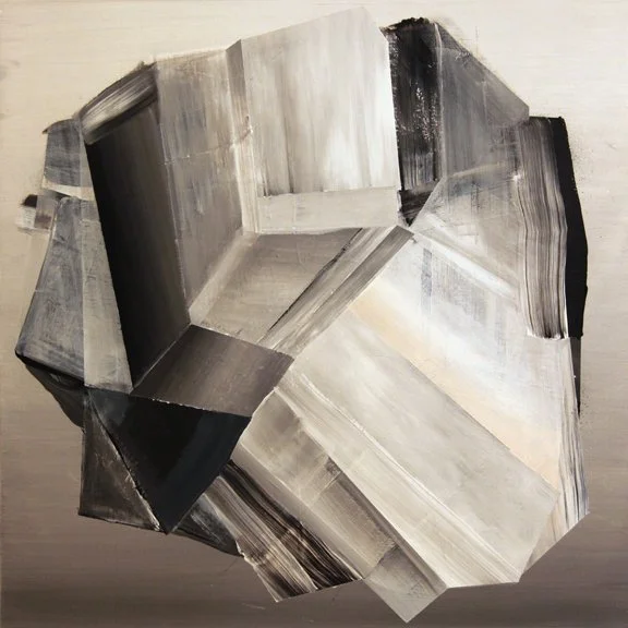 Abstract geometric sculpture made of various black, gray, and white painted metal pieces assembled in an irregular, faceted shape.