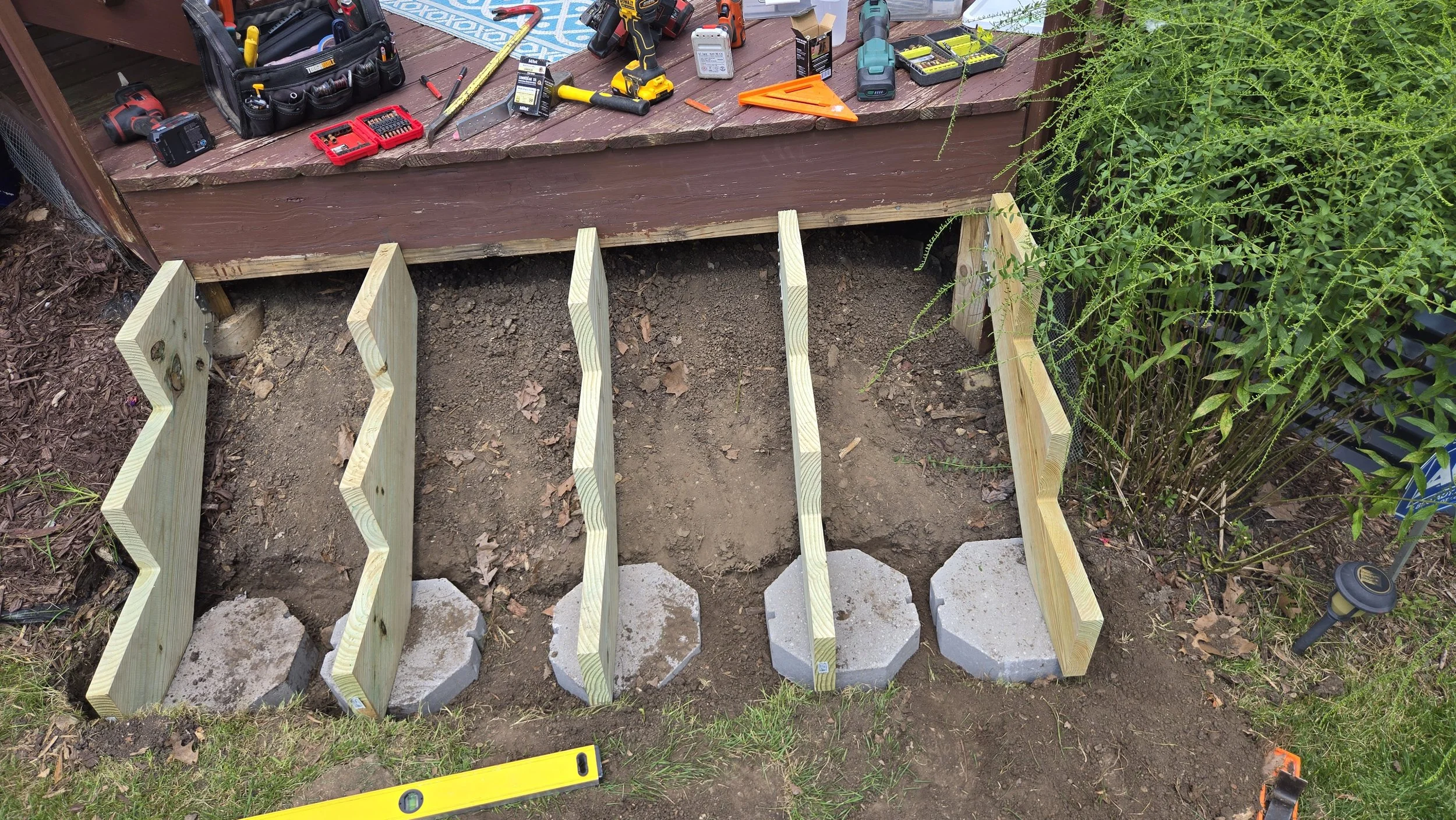 Replacing rotten deck steps with new stringers set on concrete pads