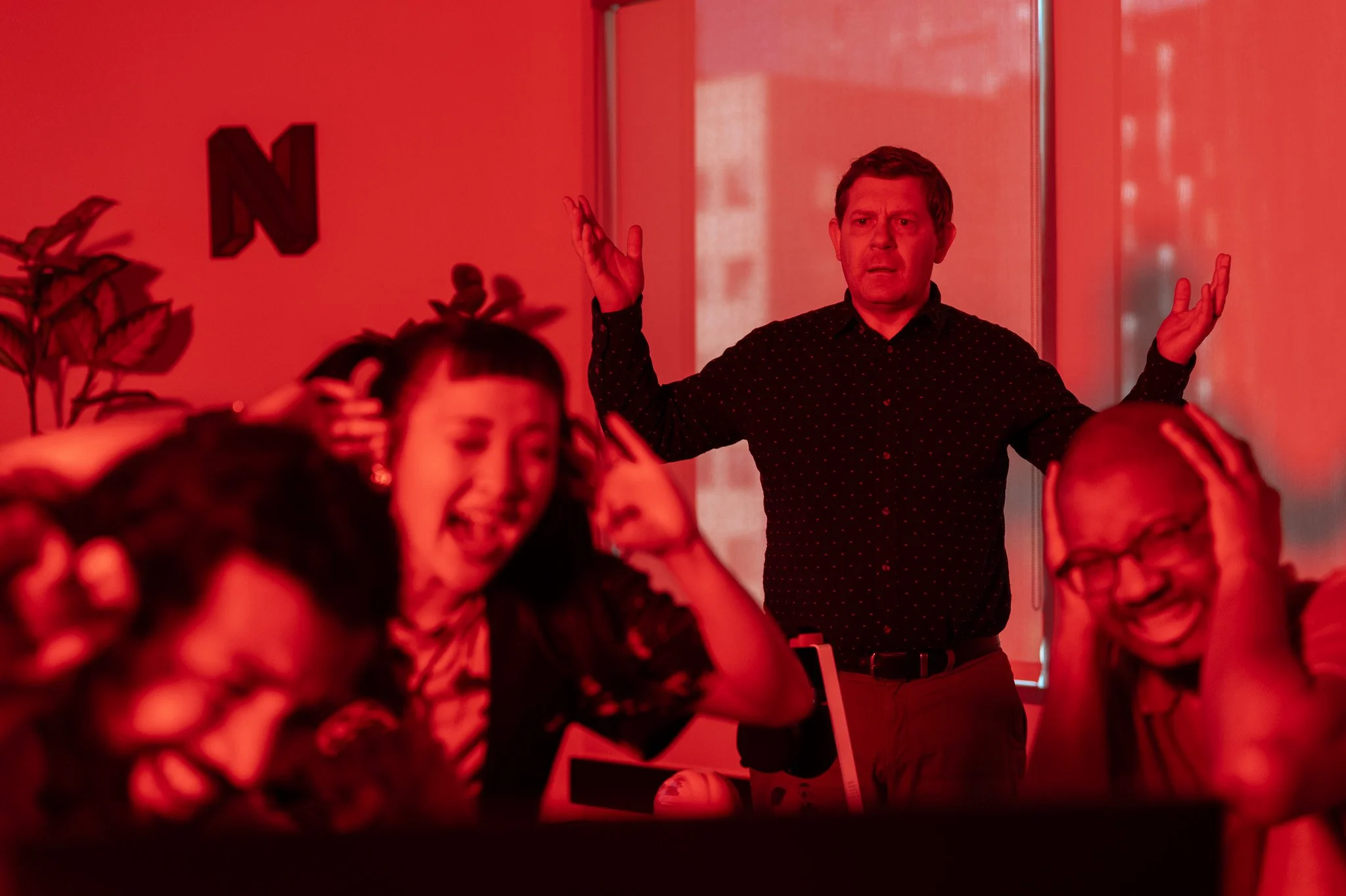 A group of people screaming in an office